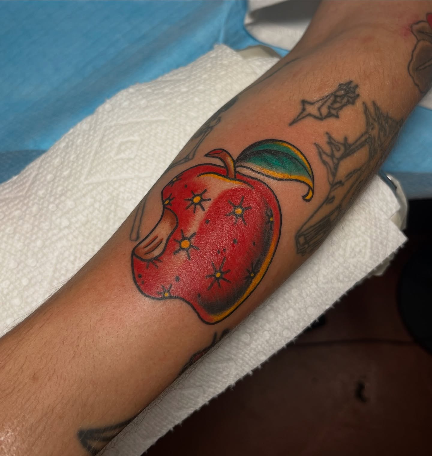 Apple American traditional tattoo on the forearm by Taylor Newton