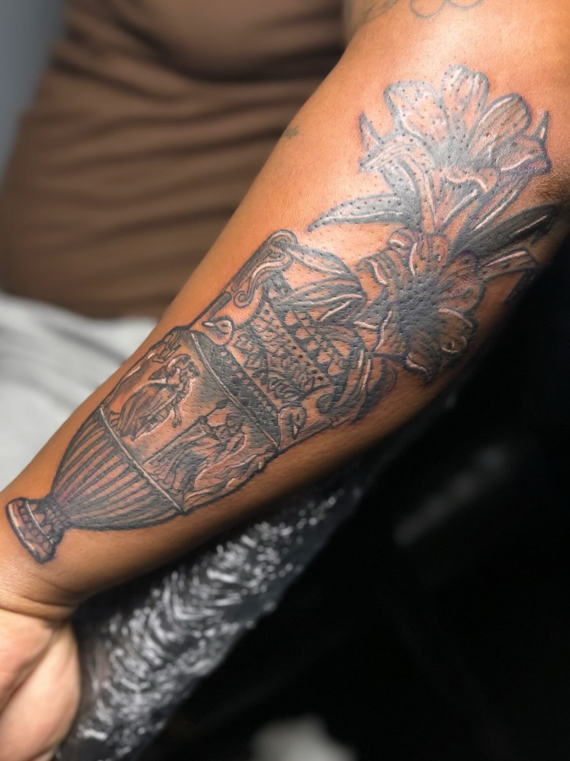 Hot air balloon and flowers black and grey tattoo on the forearm by Rell Washington, Marlow Heights, Maryland