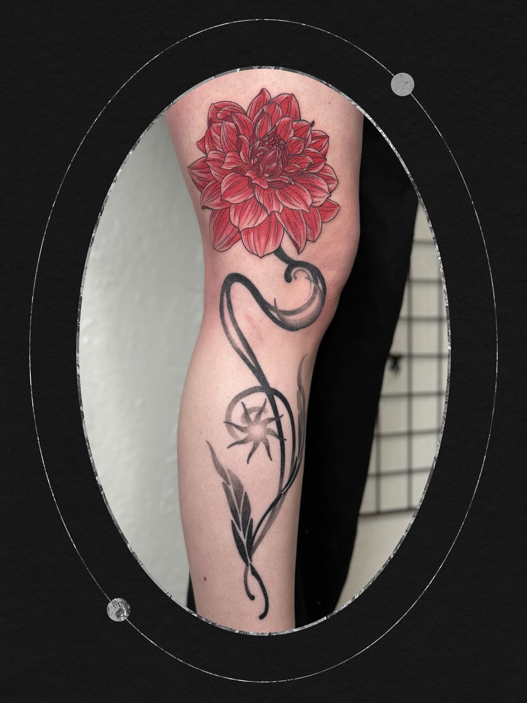 Dahlia flower black and grey tattoo on the forearm by Sydney