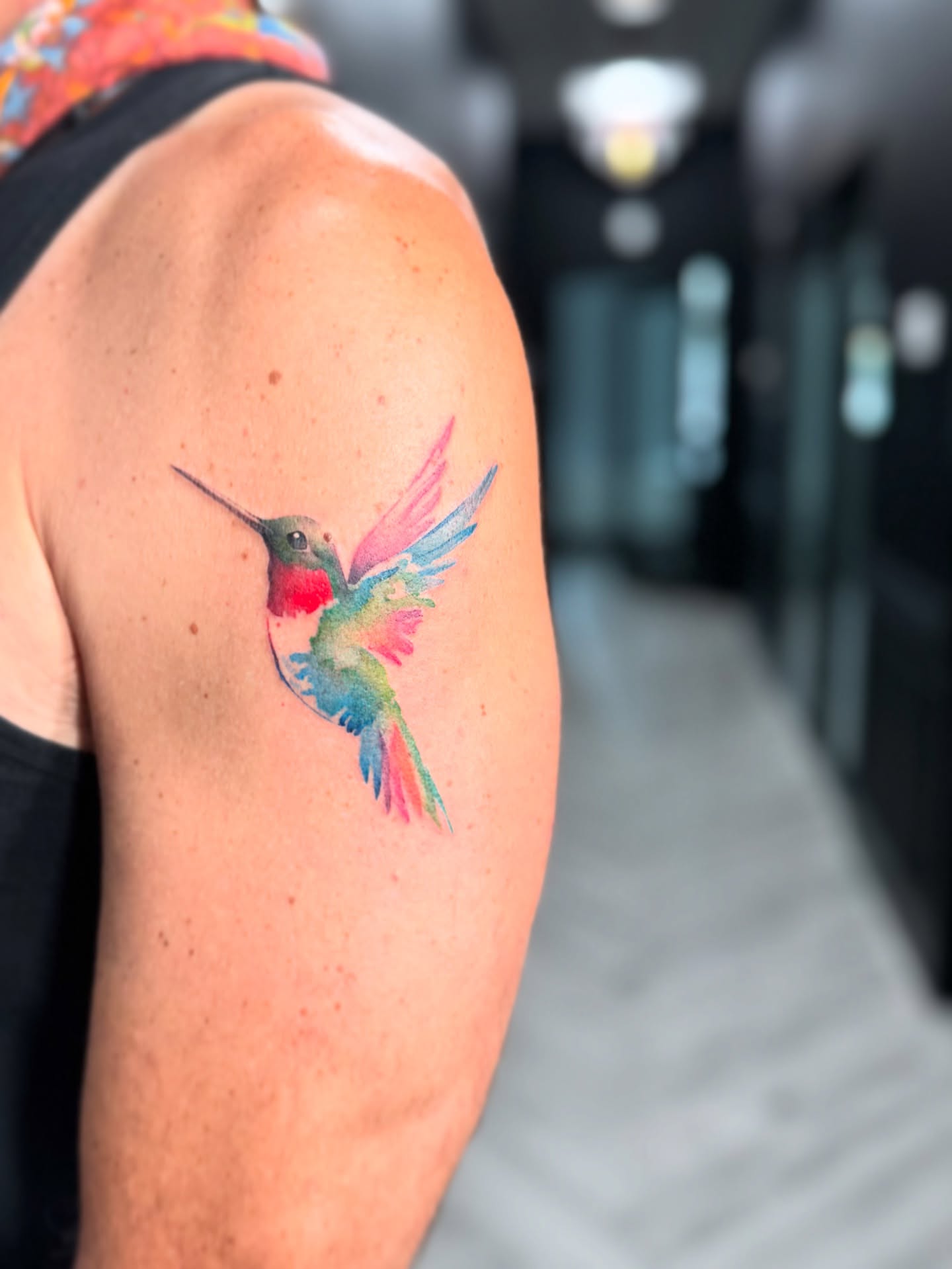 Hummingbird watercolor tattoo on the shoulder by Georgia Grey
