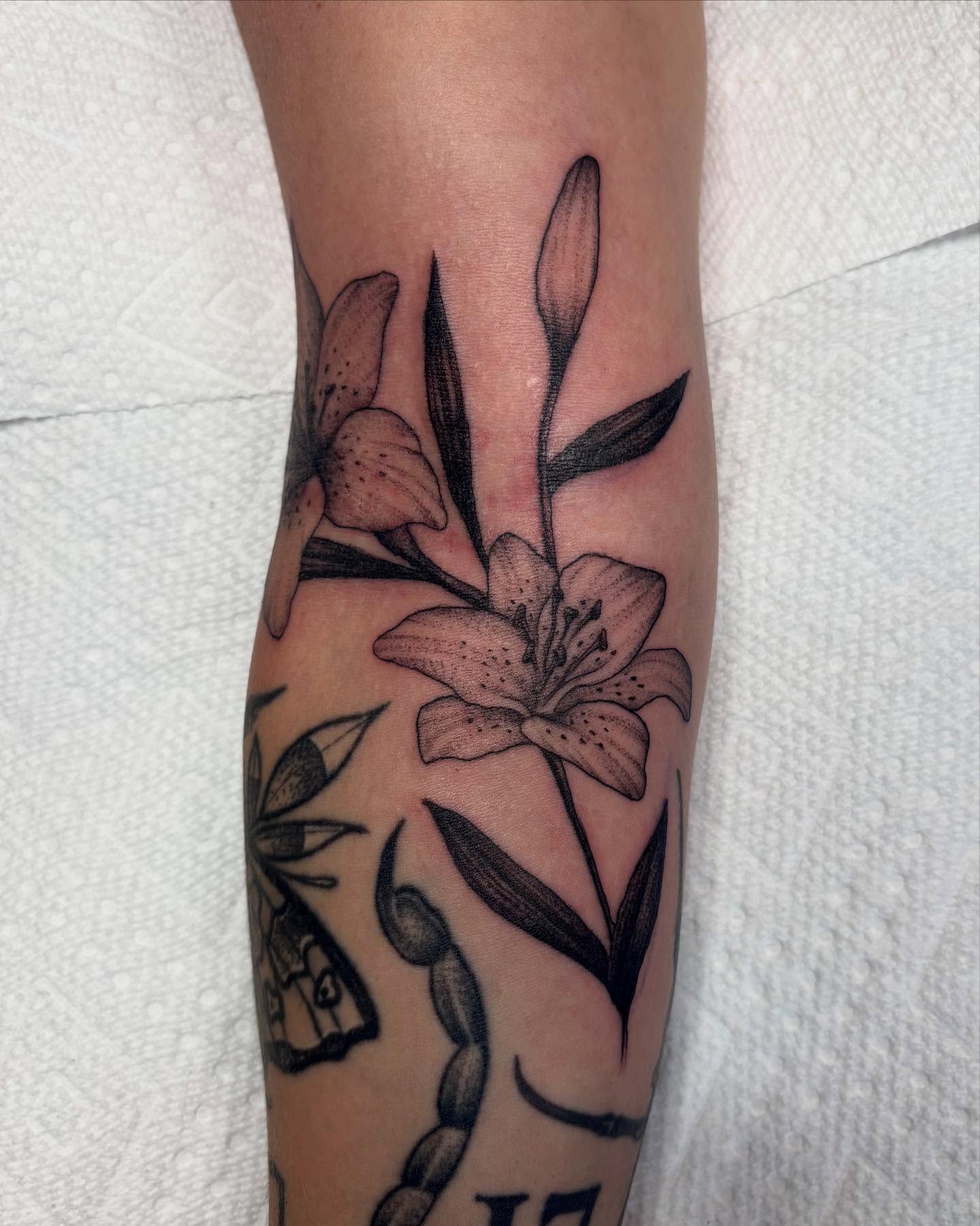 Lily black and grey tattoo on the forearm by ⟡ Sam O ⟡