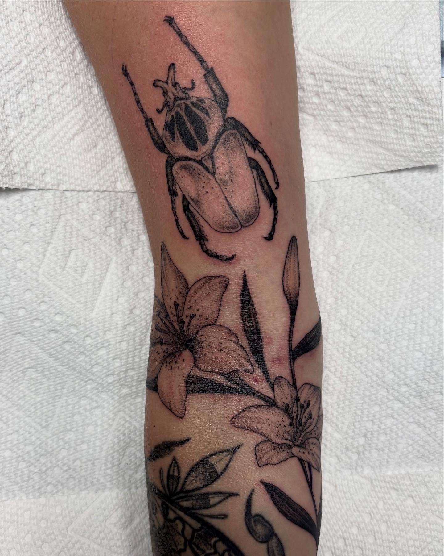 Beetle and lilies realism tattoo on the forearm by ⟡ Sam O ⟡