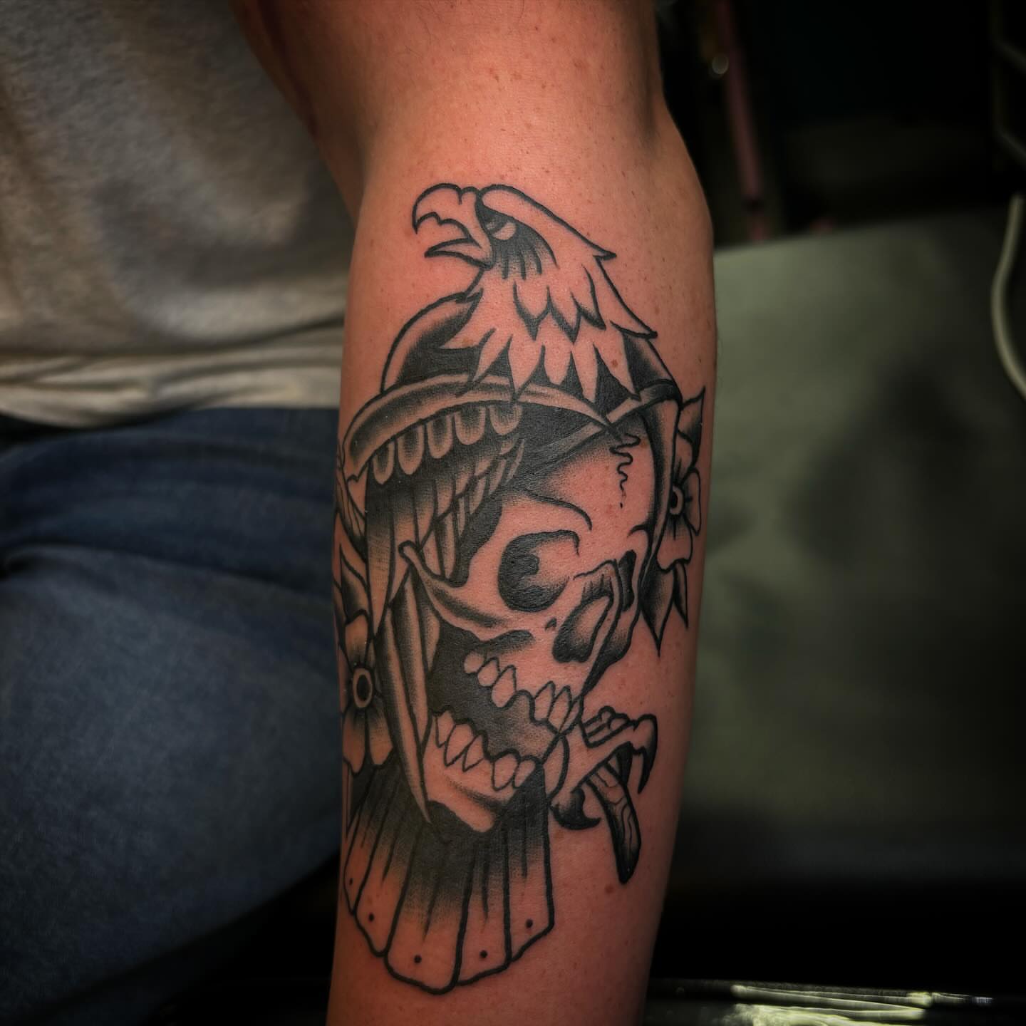 Skull with eagle black and grey tattoo on the forearm by Brett Ferguson