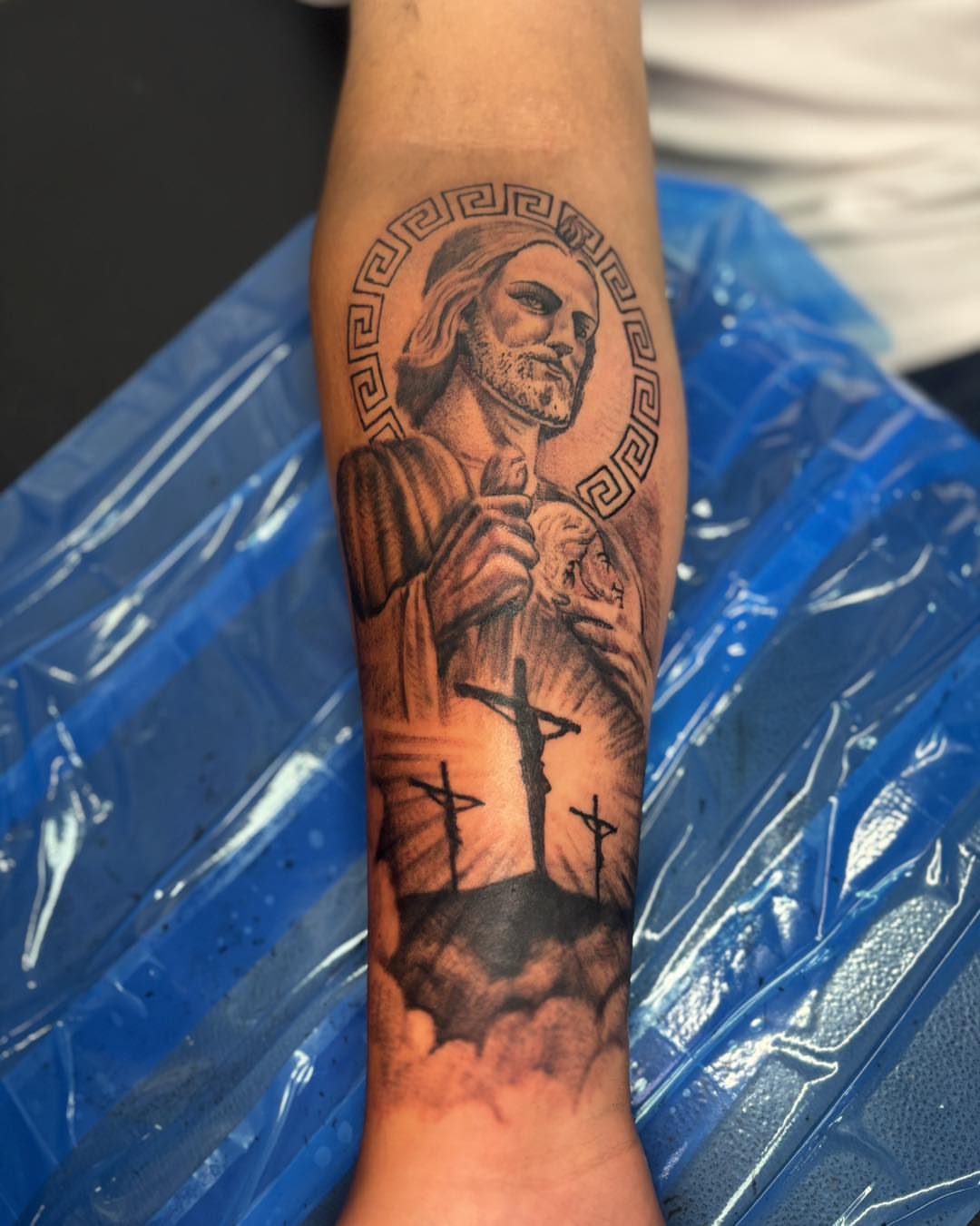 Religious figure realism tattoo on the forearm by Dre Ortiz