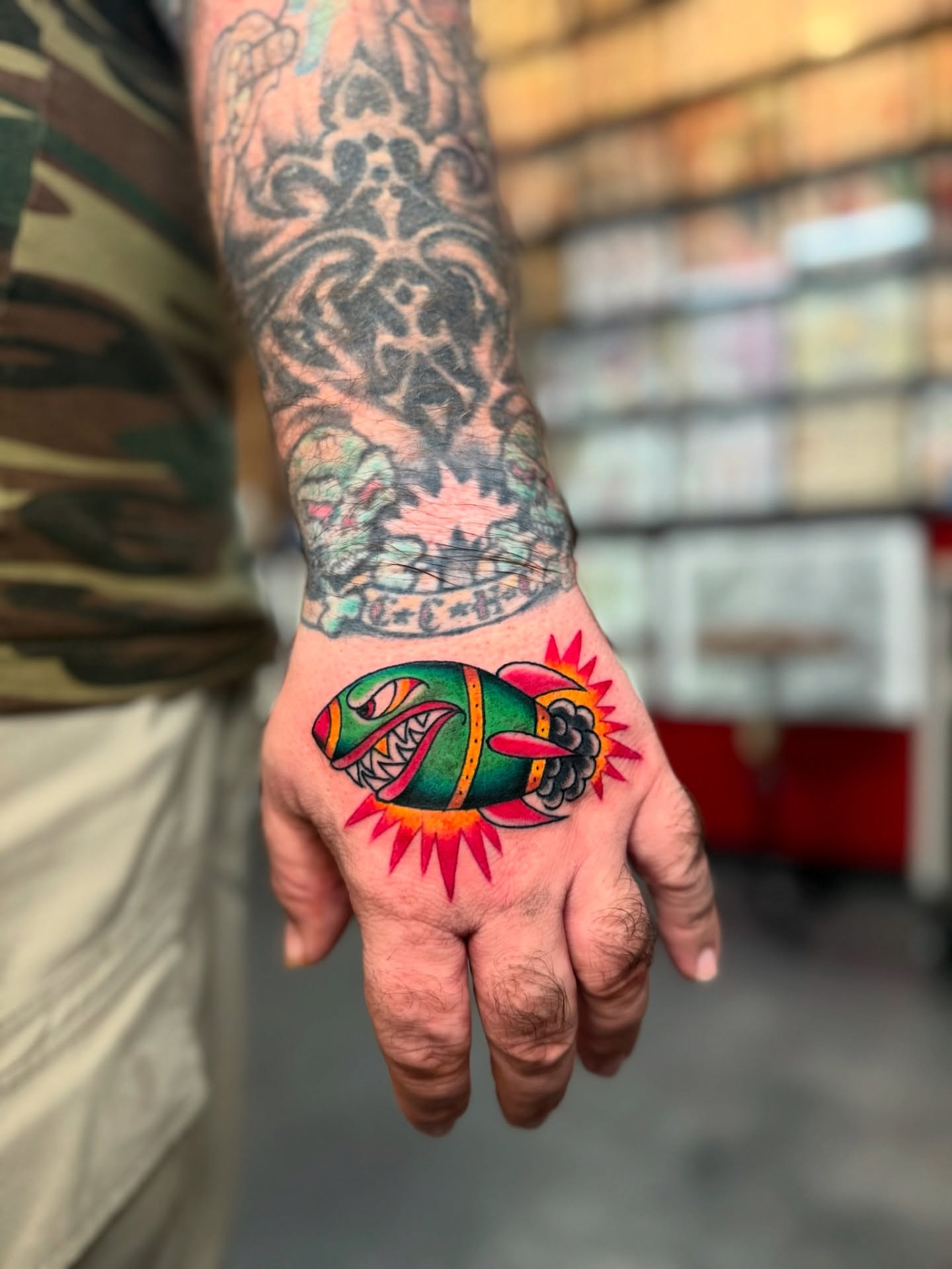 Fish and sun American traditional tattoo on the hand by Bre