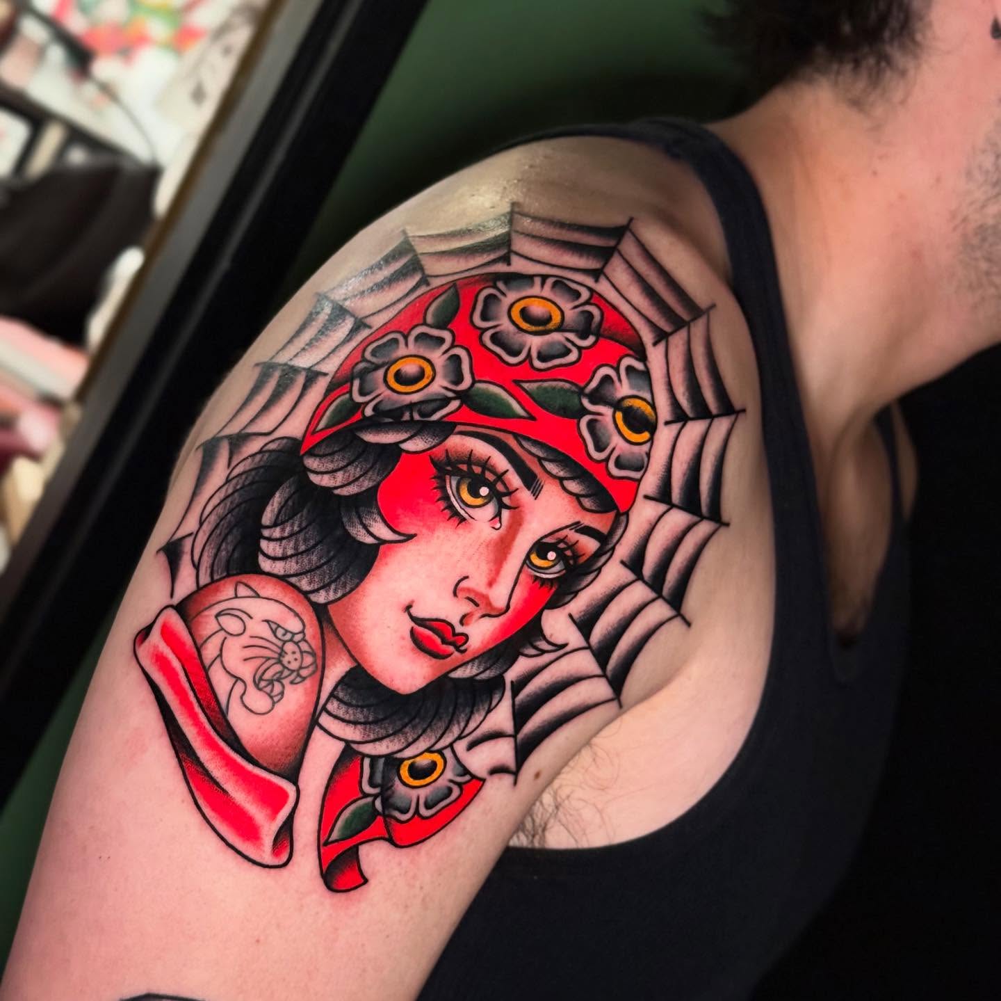 Woman with flowers American traditional tattoo on the shoulder by Chelstine, Encinitas, California