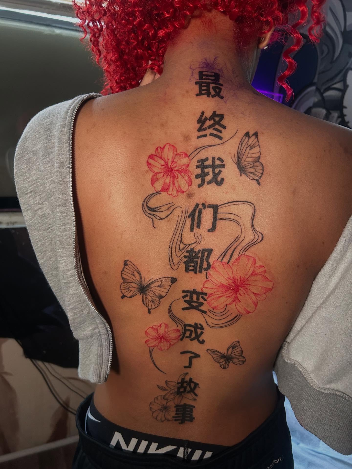 Cherry blossoms and butterflies new school tattoo on the back by Kells