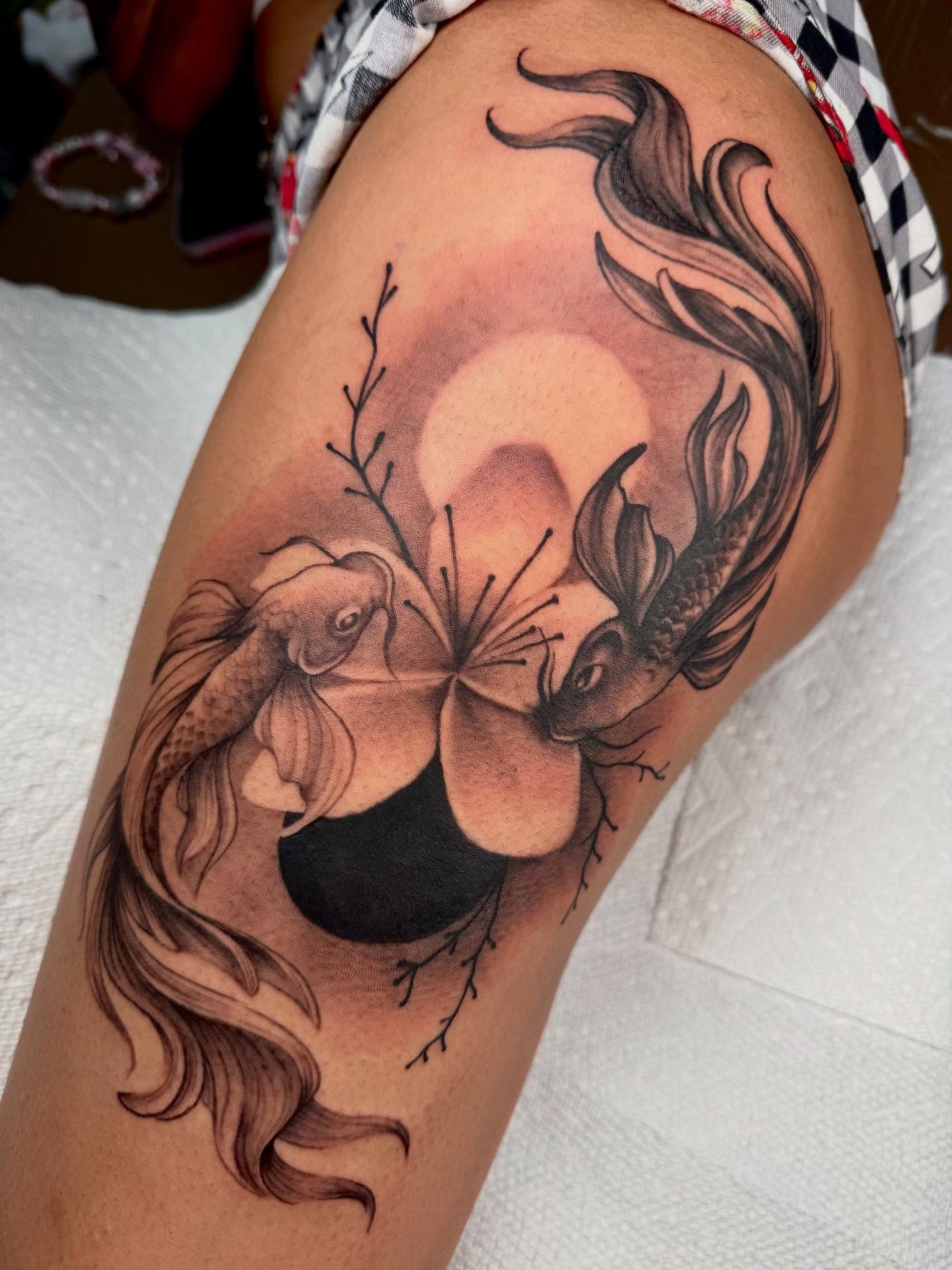 Koi fish and lotus flower realism tattoo on the thigh by Denver Tattoo Artist