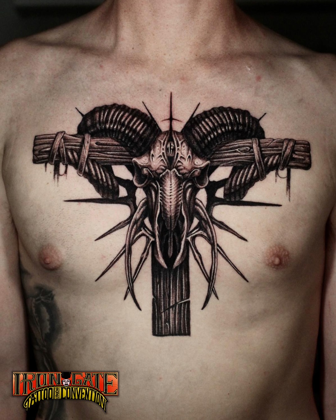 Ram skull and cross dark realism tattoo on the chest by H.black