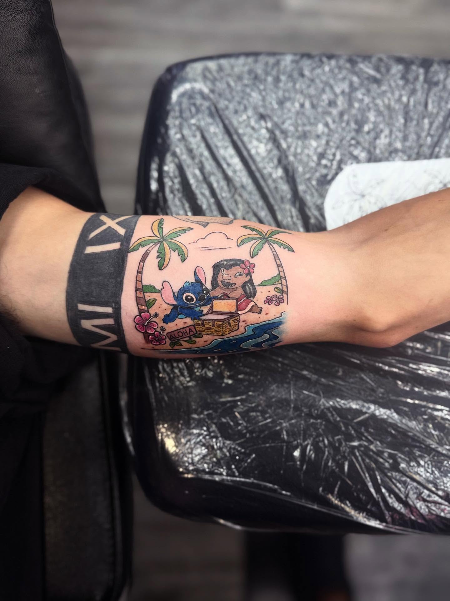 Lilo and Stitch illustrative tattoo on the forearm by Nicholas A. Estes-Davis