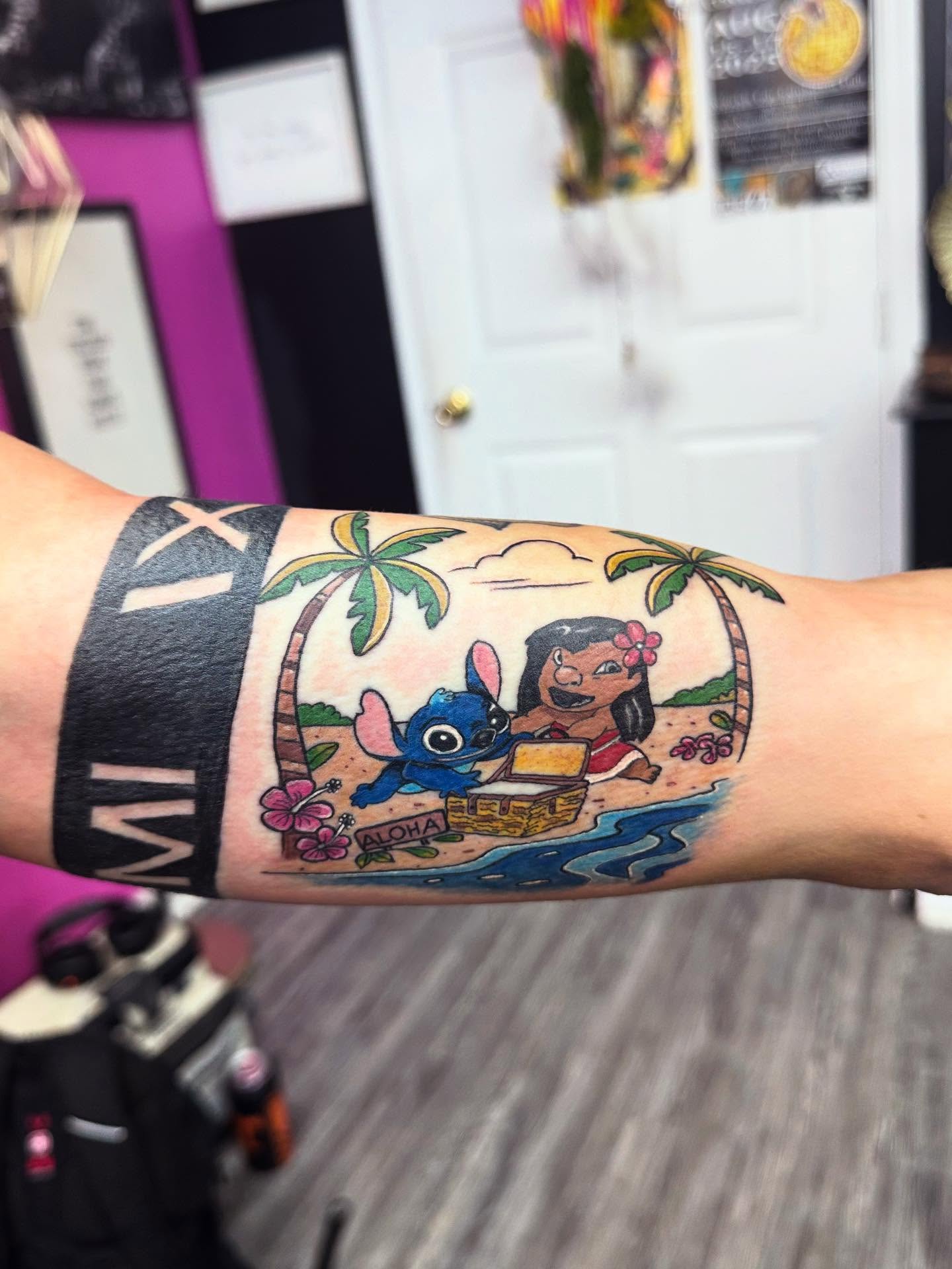 Lilo and Stitch illustrative tattoo on the forearm by Nicholas A. Estes-Davis