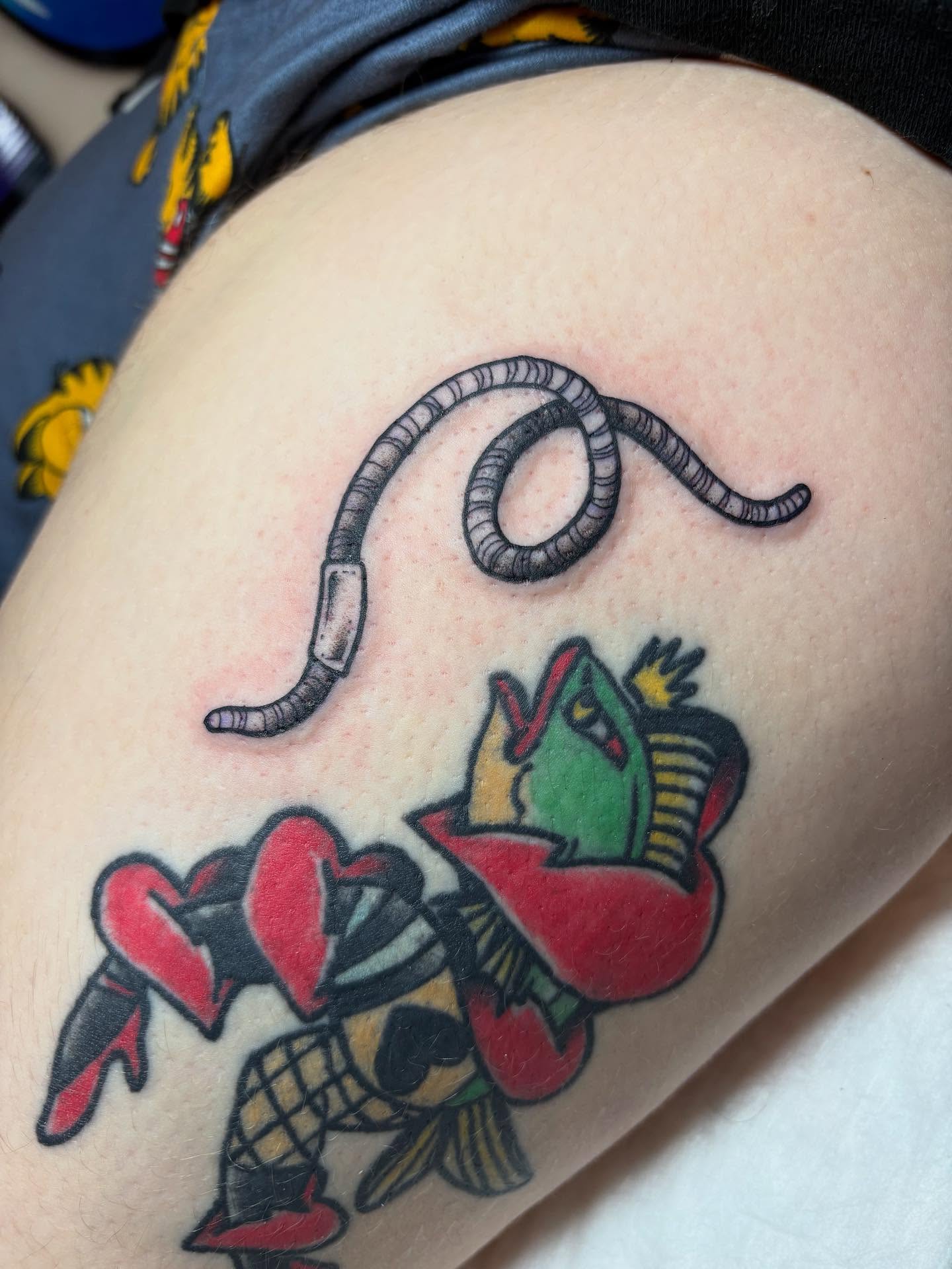 Worm and heart American traditional tattoo on the thigh by gia❤️‍🔥🎲, Maryville, Tennessee