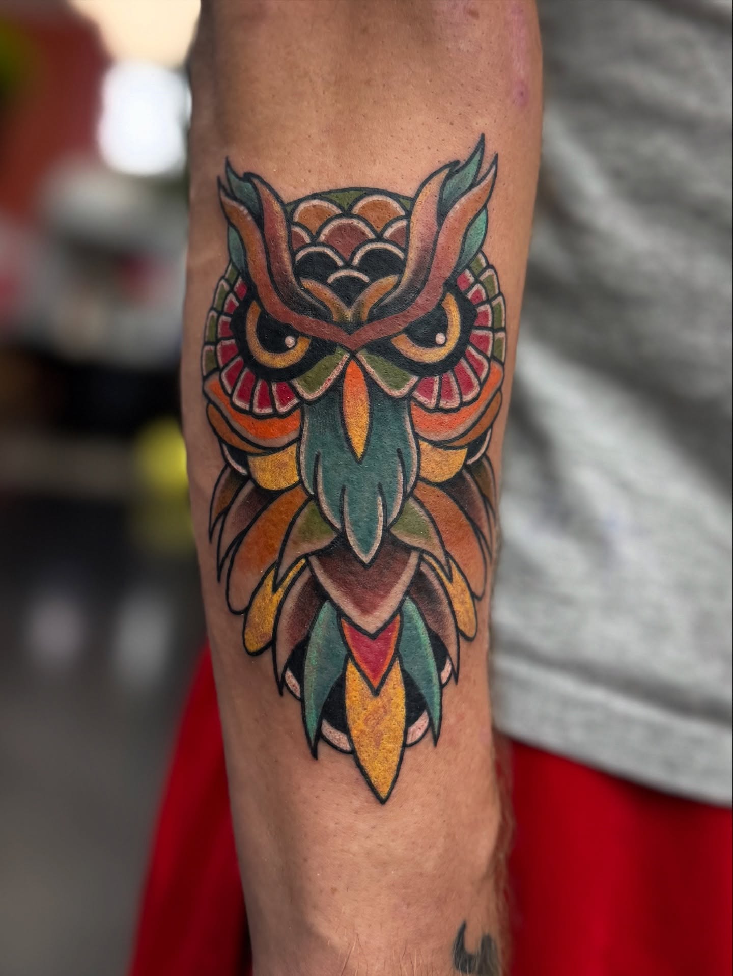 Owl American traditional tattoo on the forearm by Joshua Carter