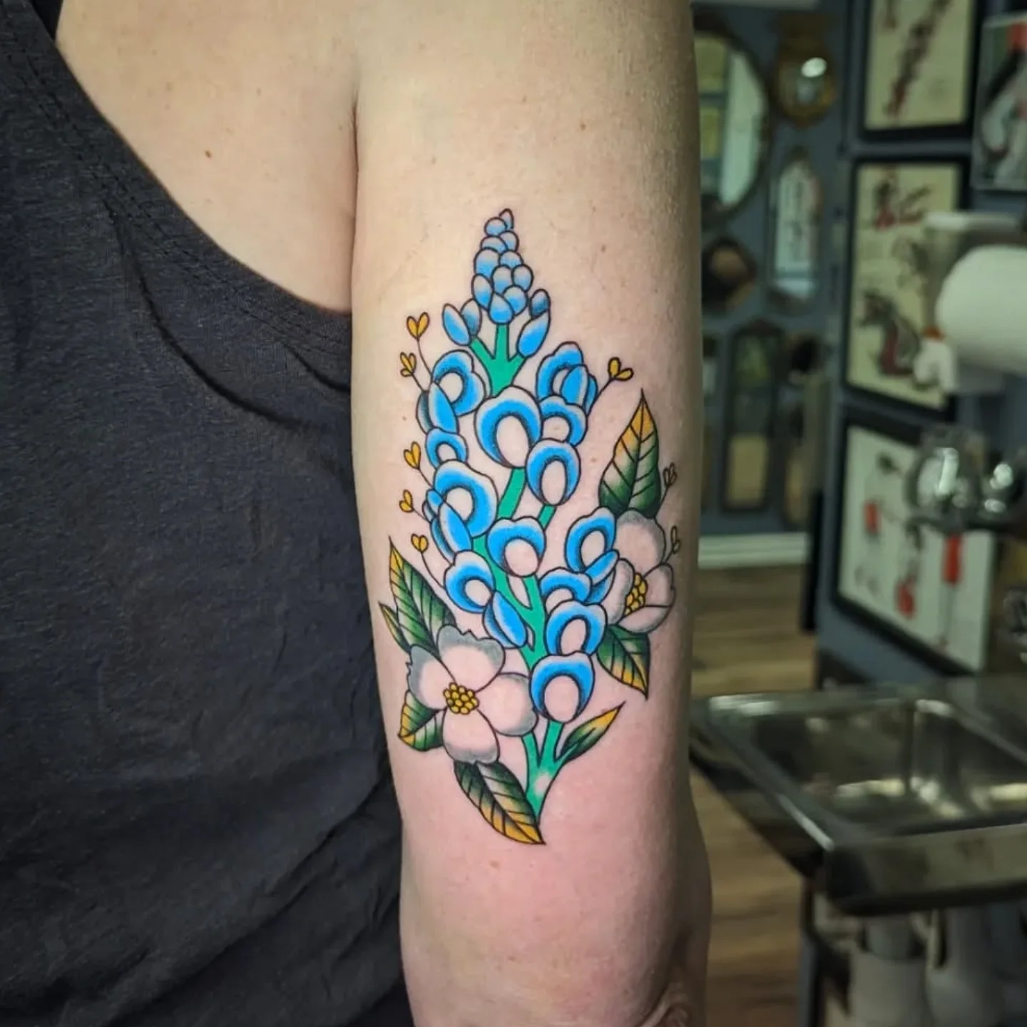 Bluebonnet bouquet American traditional tattoo on the forearm by joseph palladino