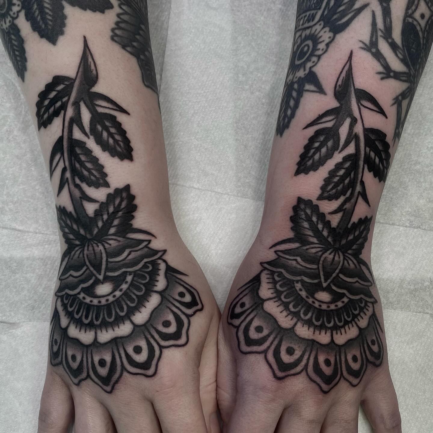 Lotus flower black and grey tattoo on the hand by Lindsey Cam Van