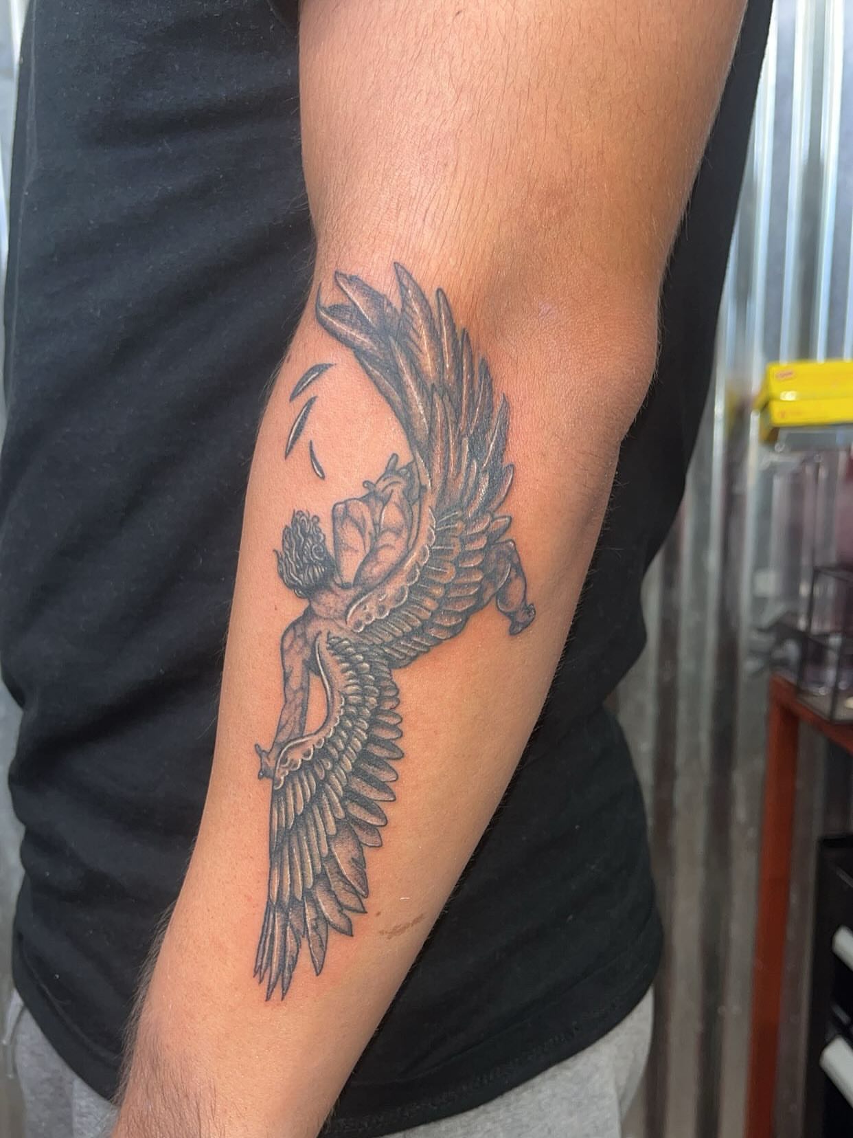 Angel with wings black and grey tattoo on the forearm by Ink by Hailey π