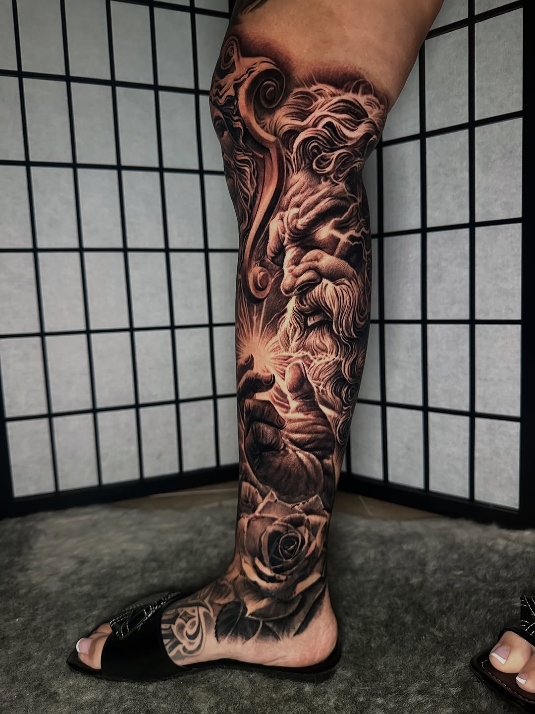 Mythological figure with roses surrealism tattoo on the calf by Anthony Ramirez