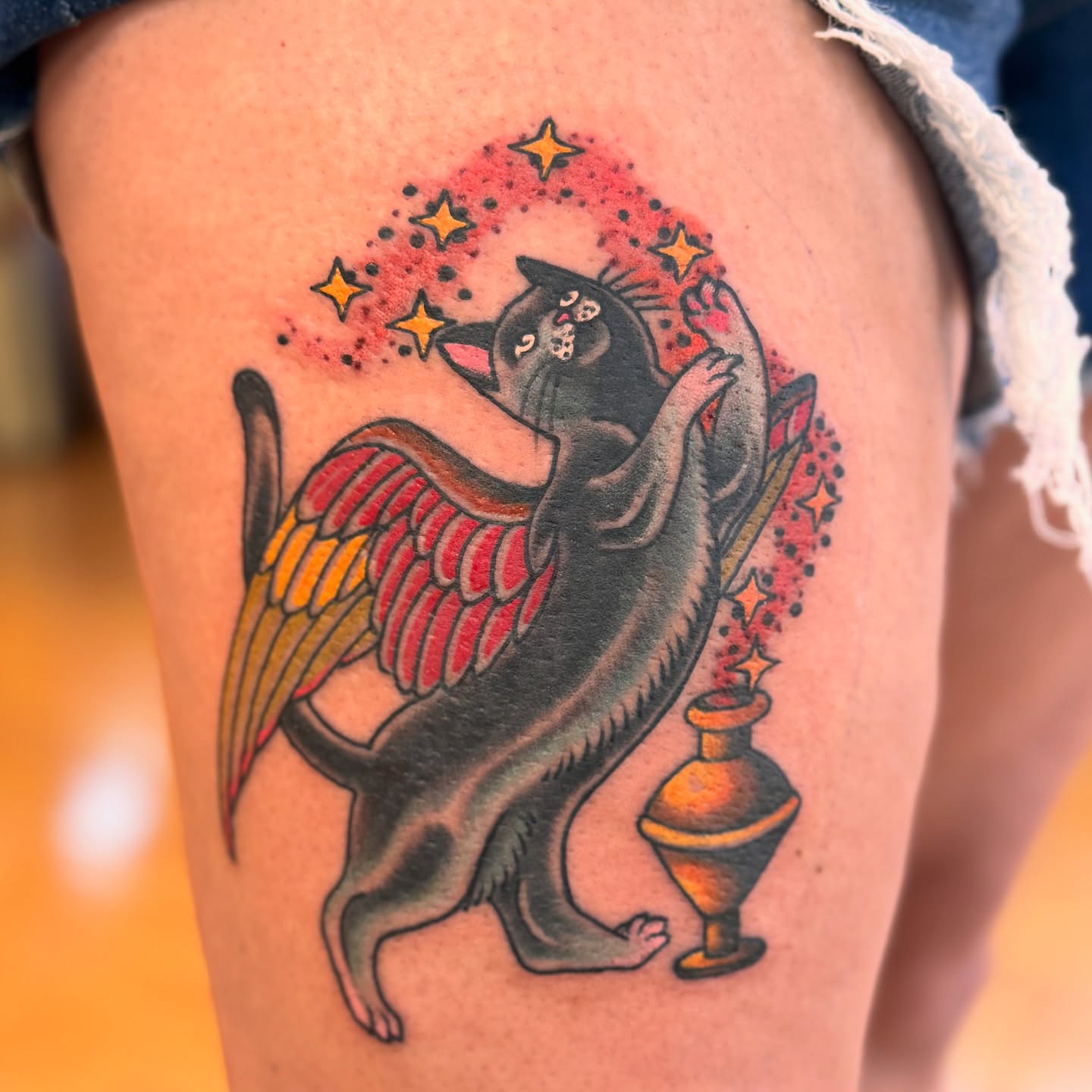 Cat with wings American traditional tattoo on the thigh by Brian Hutflies