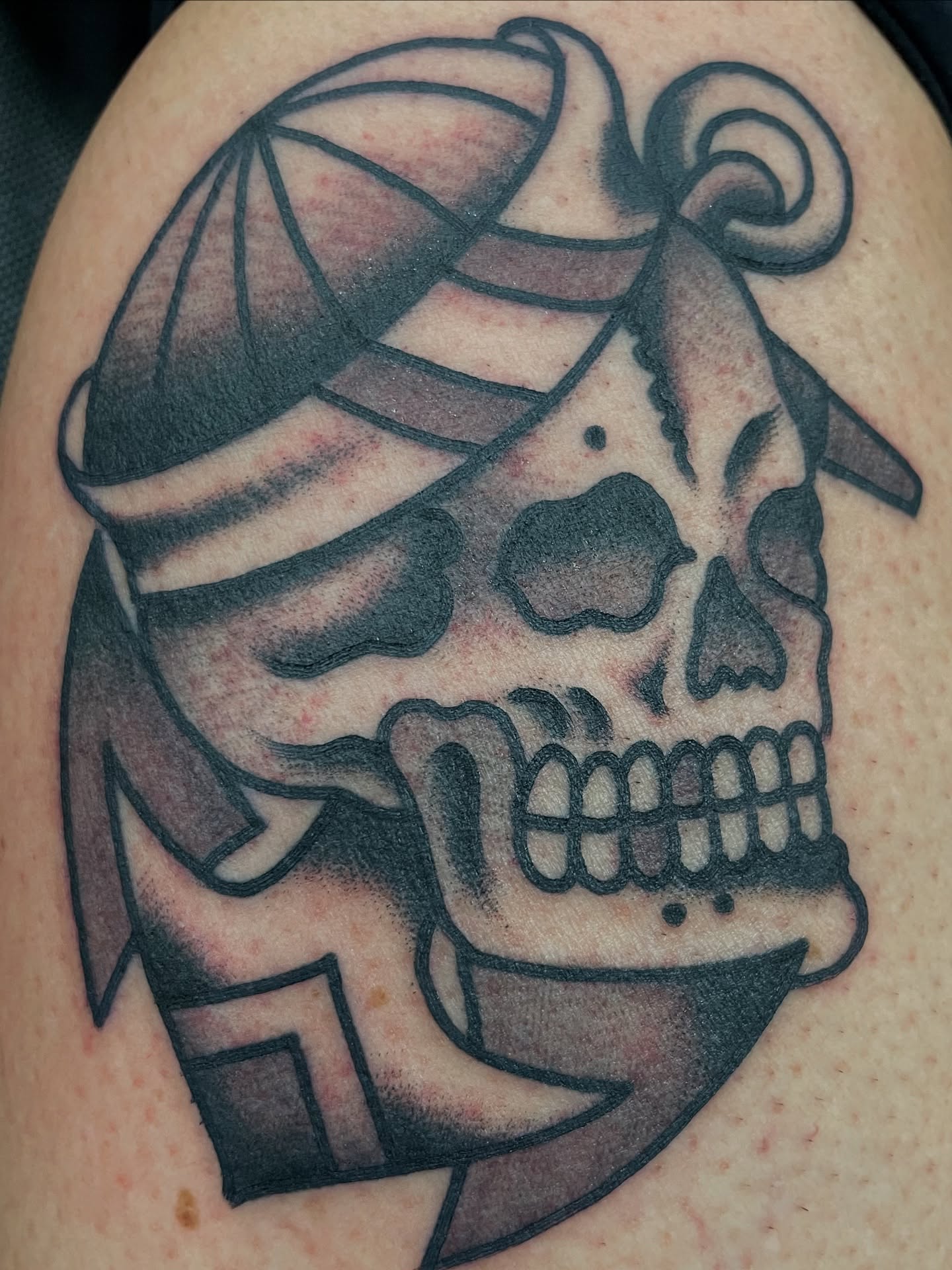 Skull with bandana black and grey tattoo on the shoulder by matt nelson