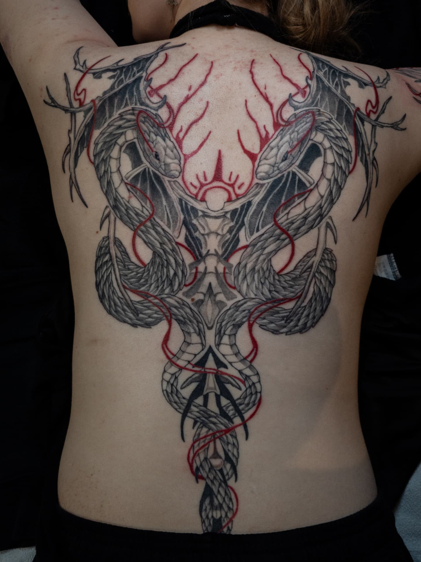 Serpent geometric tattoo on the back by EyeSee Tattoos