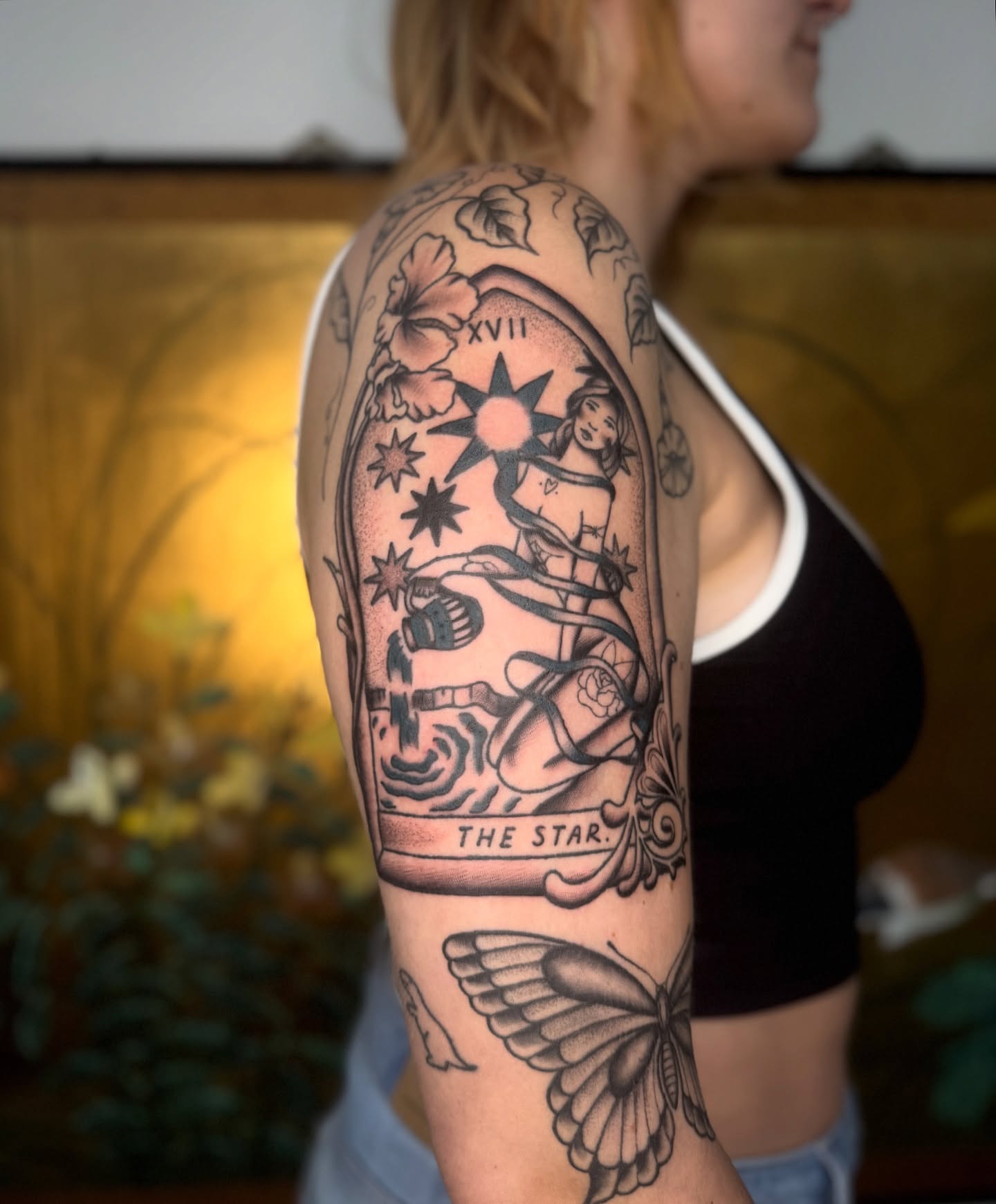 The star tarot card American traditional tattoo on the upper arm by Mazie