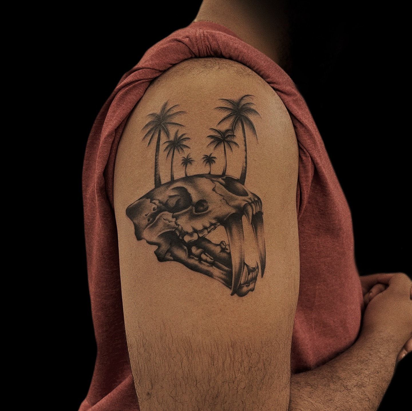 Skull and palm trees black and grey tattoo on the shoulder by Jason