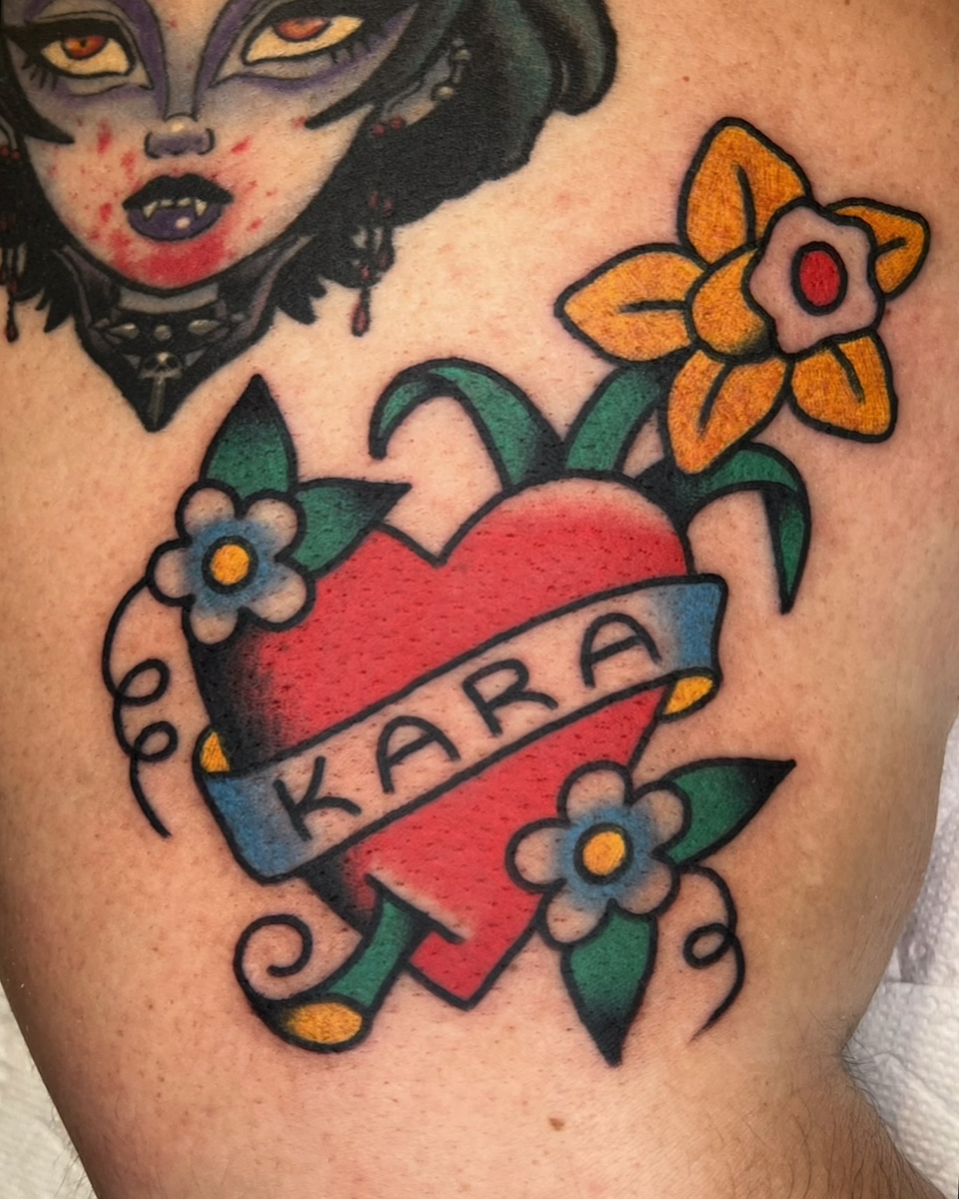 Heart with name American traditional tattoo on the thigh by Robyn Fricke