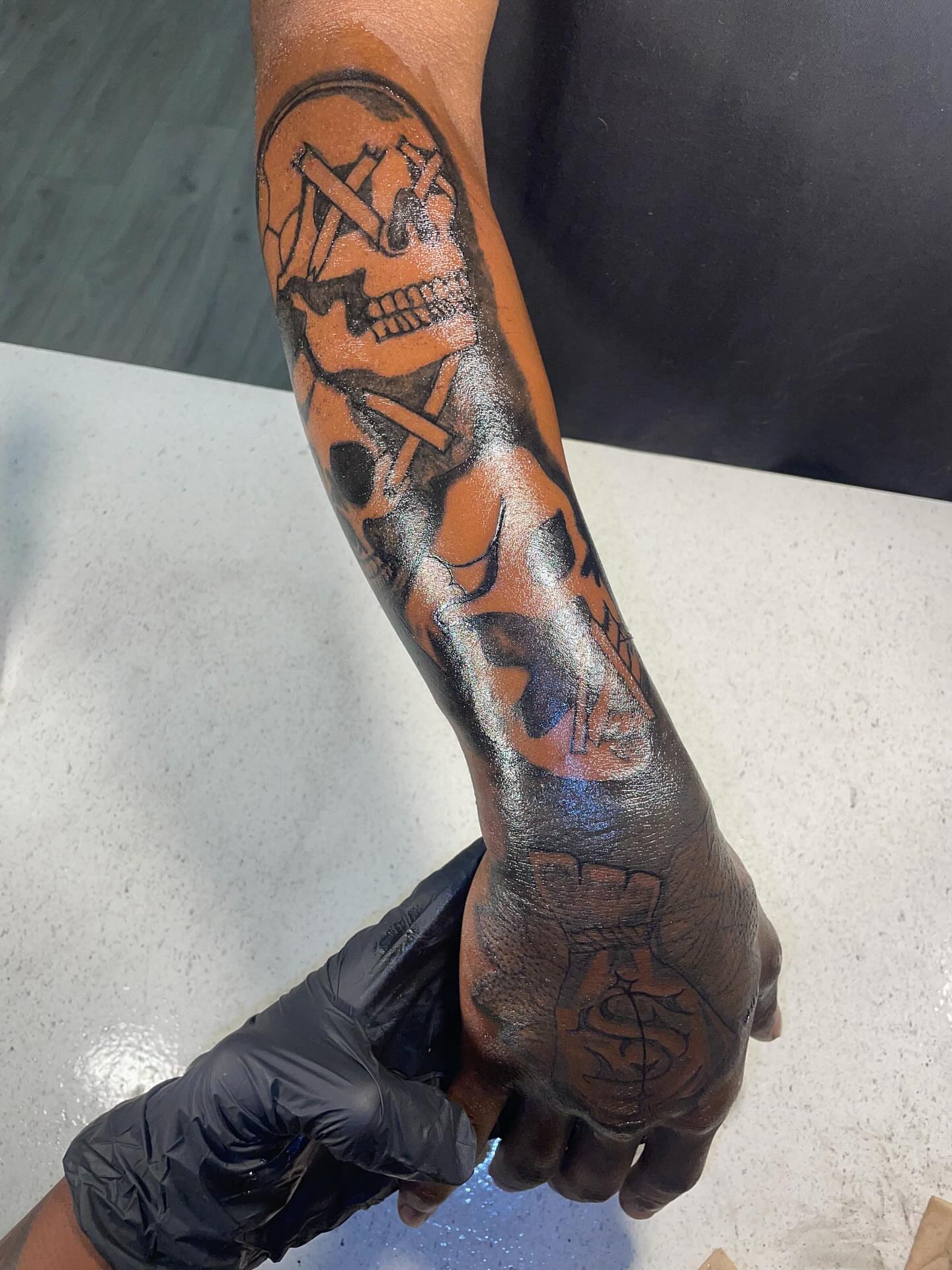 Skull and crossbones American traditional tattoo on the forearm by Dm To Book ๐, Charlotte, North Carolina