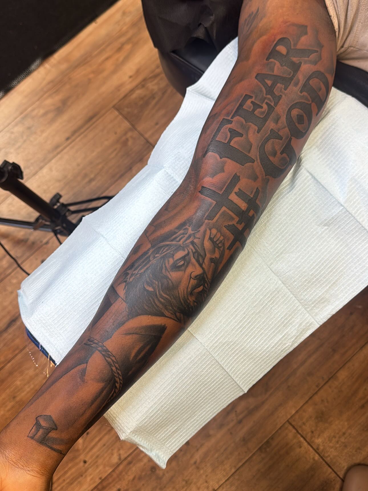 Religious figure black and grey tattoo on the forearm by Cedric Fleming