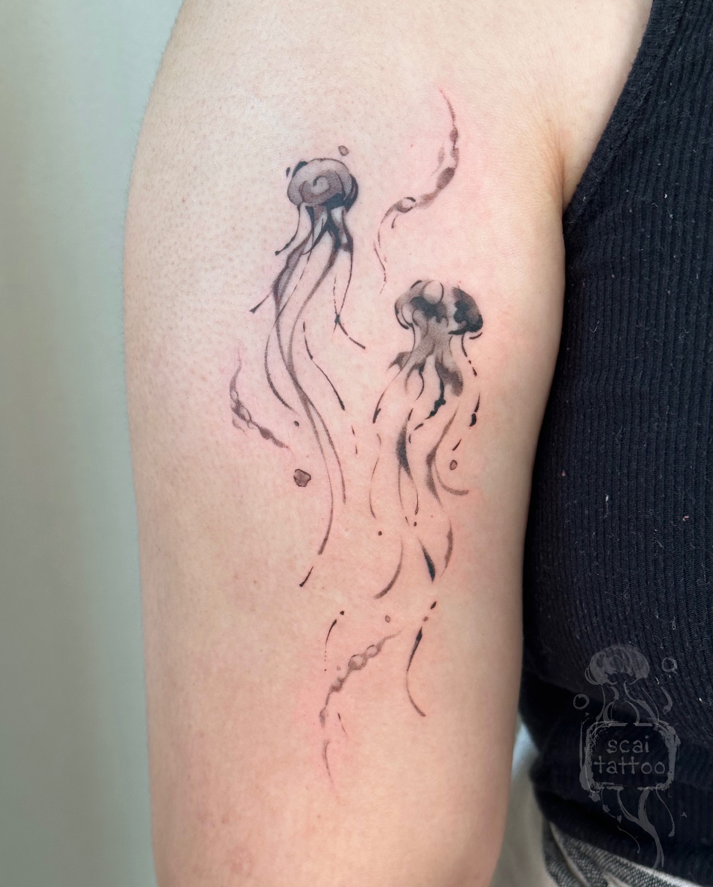 Jellyfish watercolor tattoo on the forearm by scaitattoo