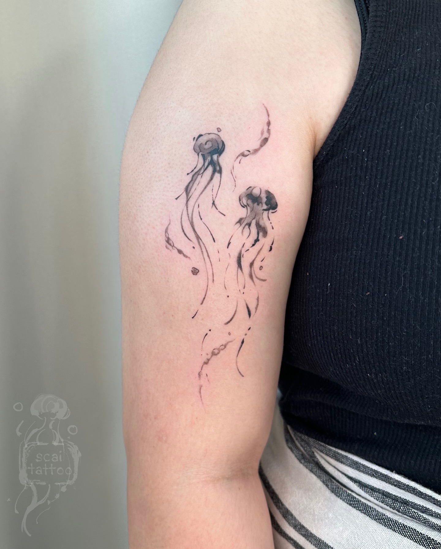 Jellyfish watercolor tattoo on the forearm by scaitattoo