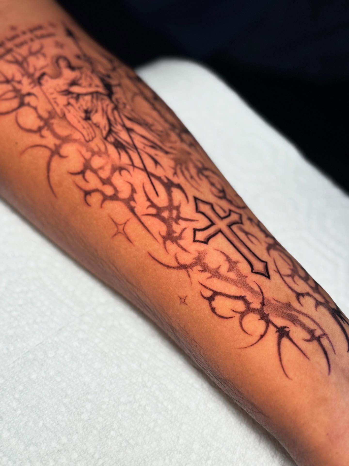 Cross and thorns black and grey tattoo on the forearm by Marquis Neal