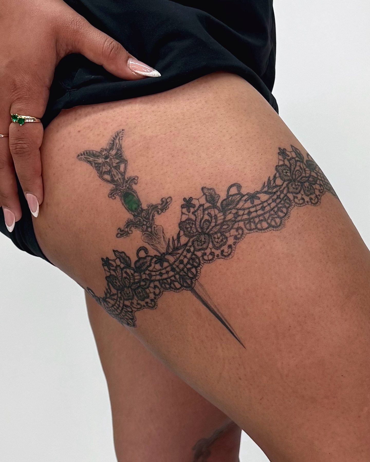 Lace and dagger black and grey tattoo on the thigh by Mystikal Blue Casares