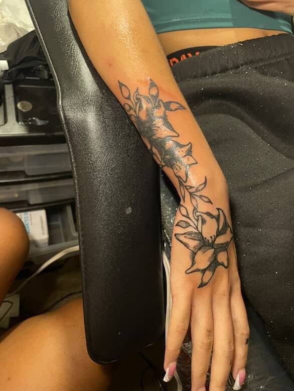 Lily flowers black and grey tattoo on the forearm by Dm To Book ๐, Charlotte, North Carolina