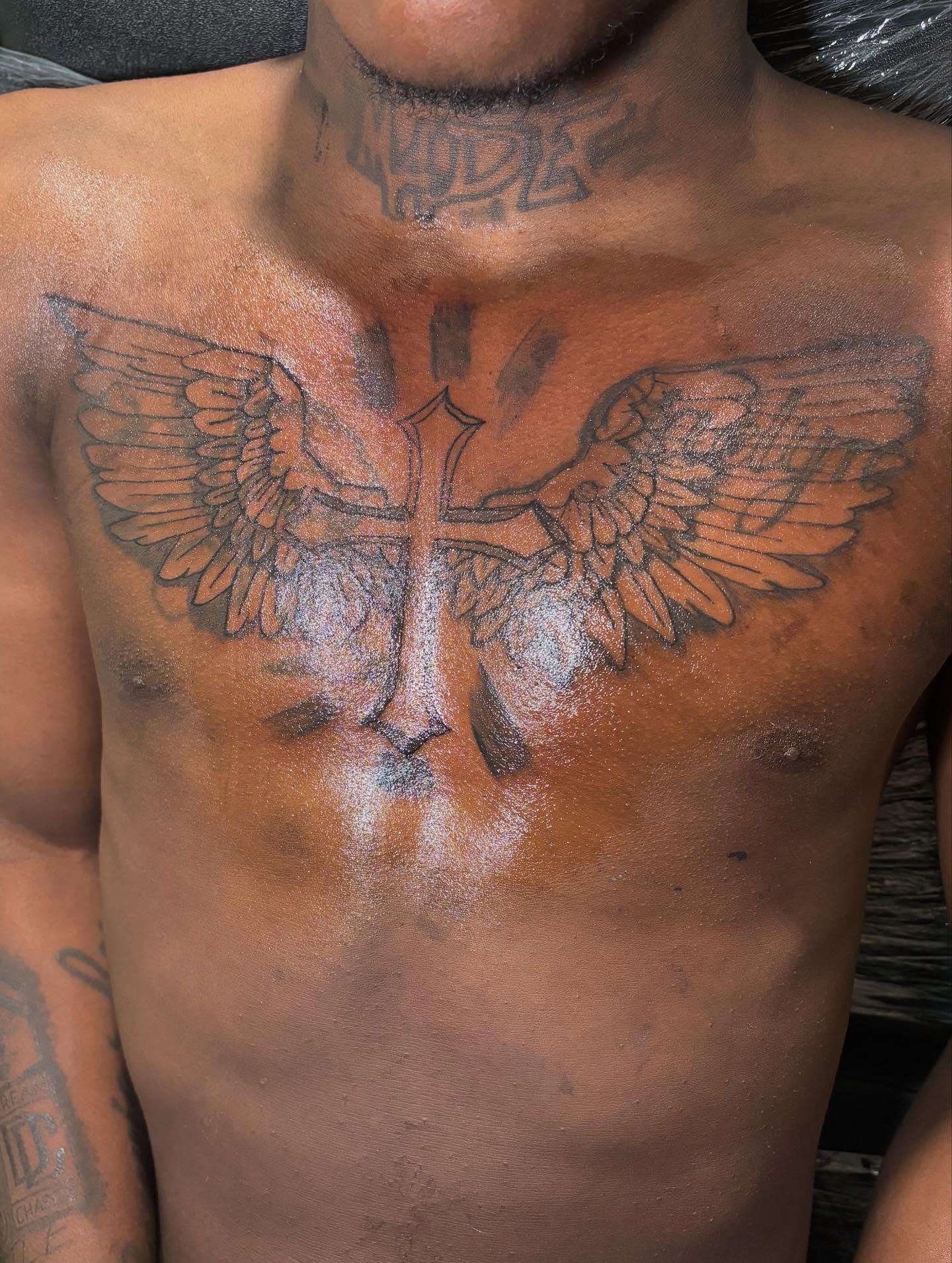 Cross with wings black and grey tattoo on the chest by Dm To Book ๐, Charlotte, North Carolina