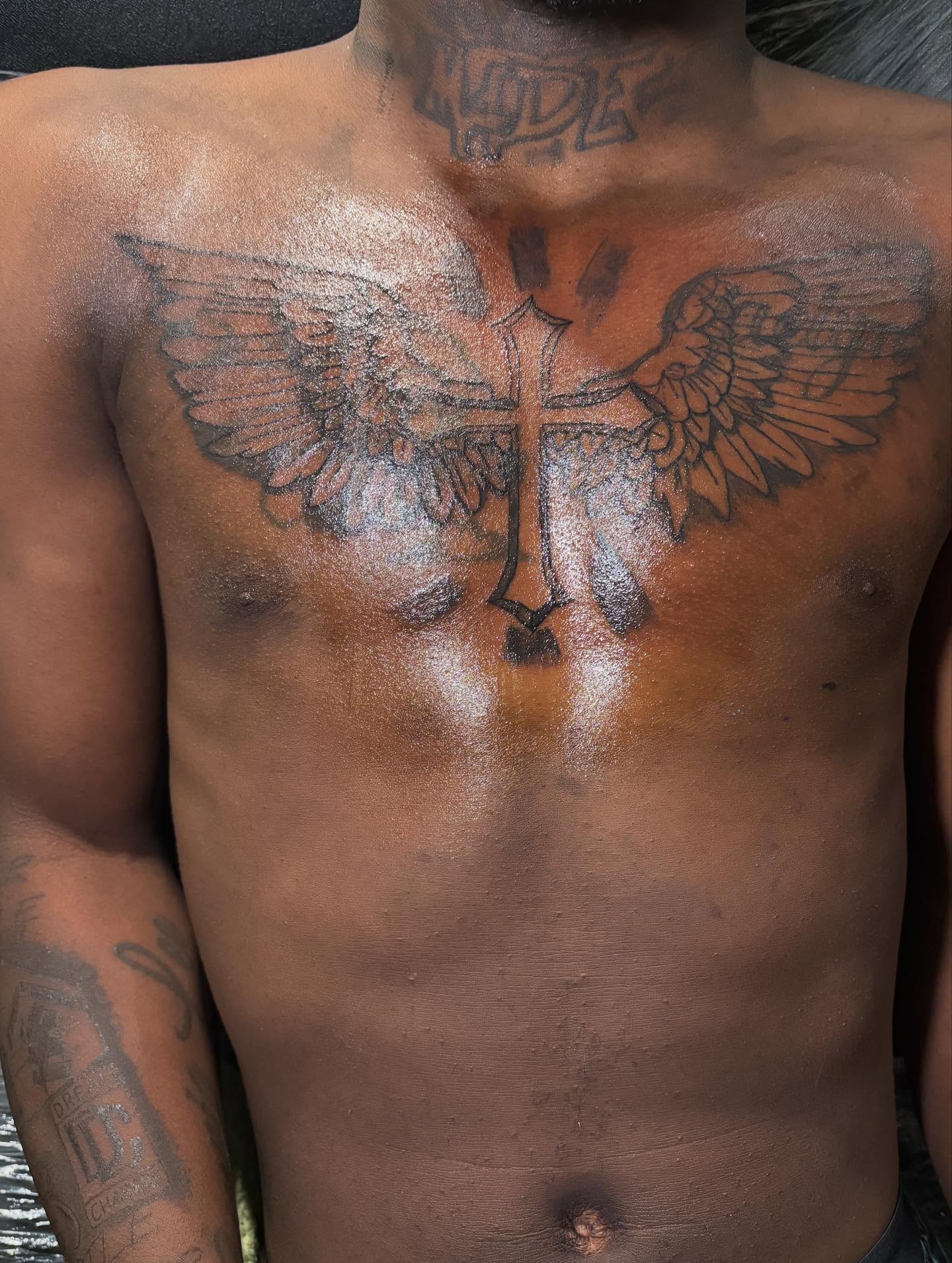 Cross with wings black and grey tattoo on the chest by Dm To Book ๐, Charlotte, North Carolina