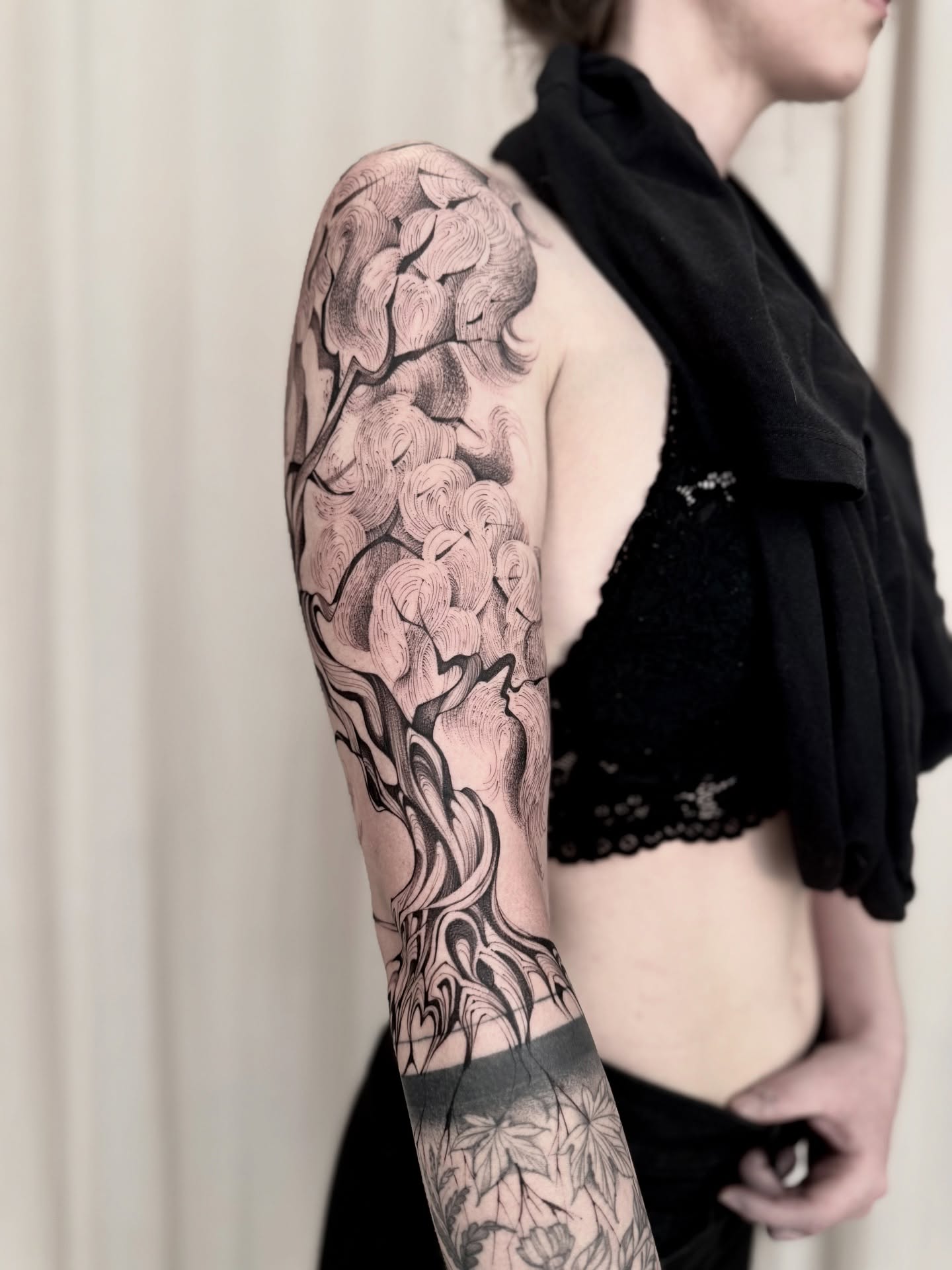 Clouds black and grey tattoo on the upper arm by Dung Ngo