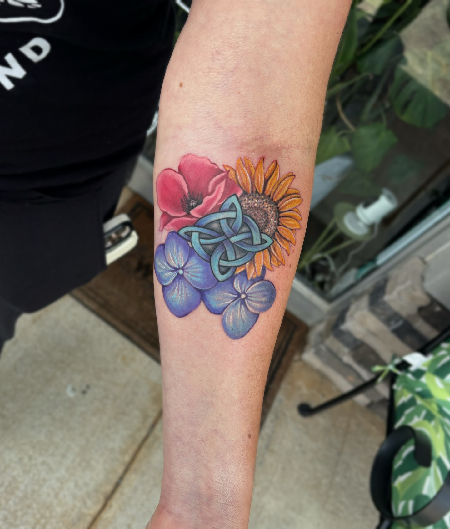 Flowers and knot watercolor tattoo on the forearm by Bunny Noel