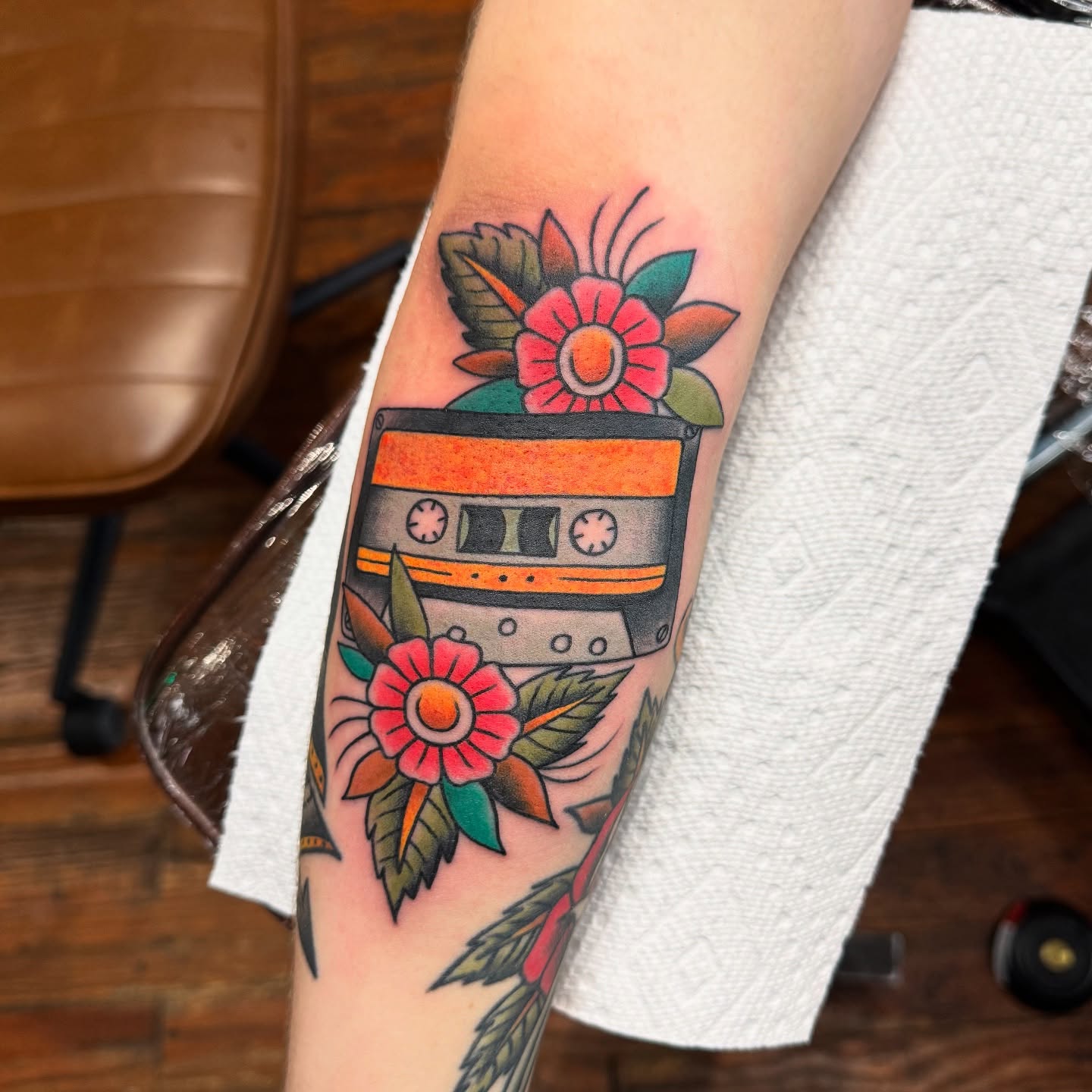 Cassette tape and flowers American traditional tattoo on the forearm by kenneth nash