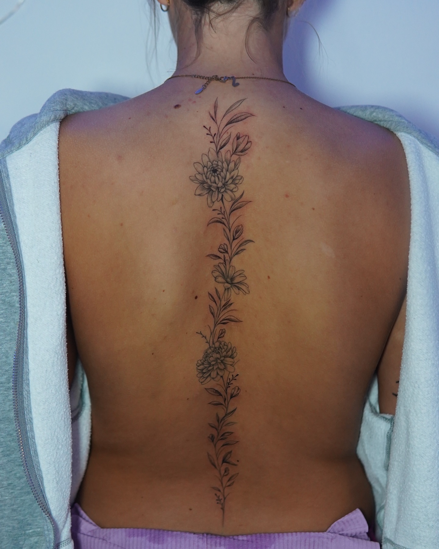 Floral arrangement black and grey tattoo on the back by Marissa S., Lansing, Michigan