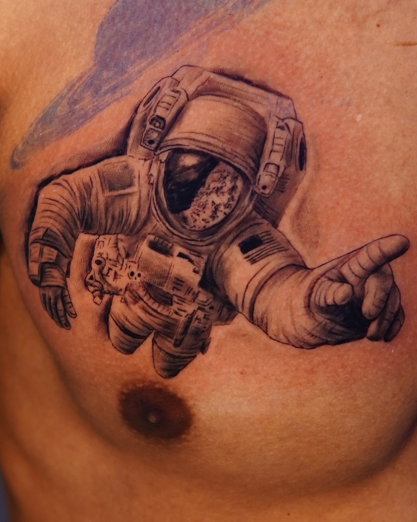 Astronaut realism tattoo on the chest by Marissa S., Lansing, Michigan