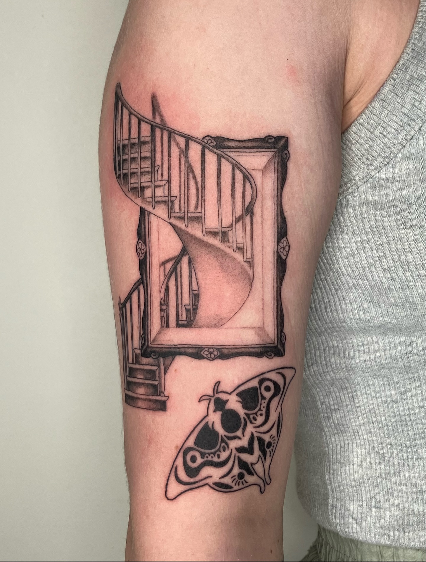Staircase and moth realism tattoo on the forearm by Hunter McGinnis