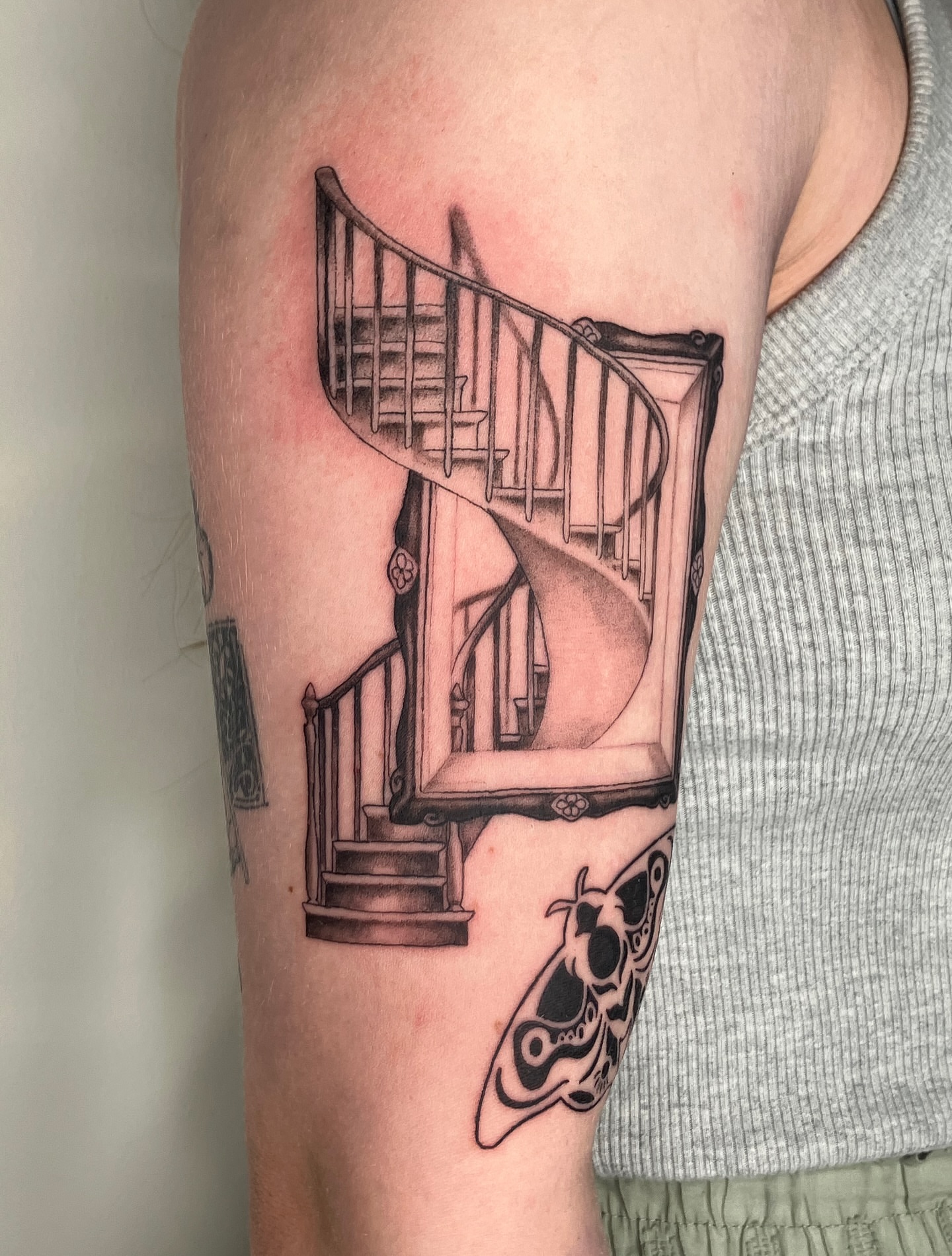 Spiral staircase realism tattoo on the forearm by Hunter McGinnis