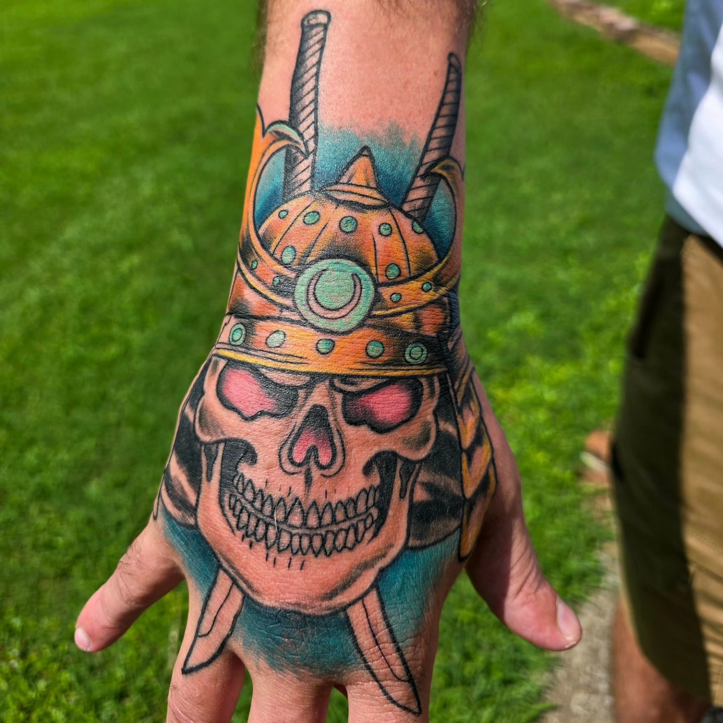 Skull wearing helmet American traditional tattoo on the hand by Michael Latendresse
