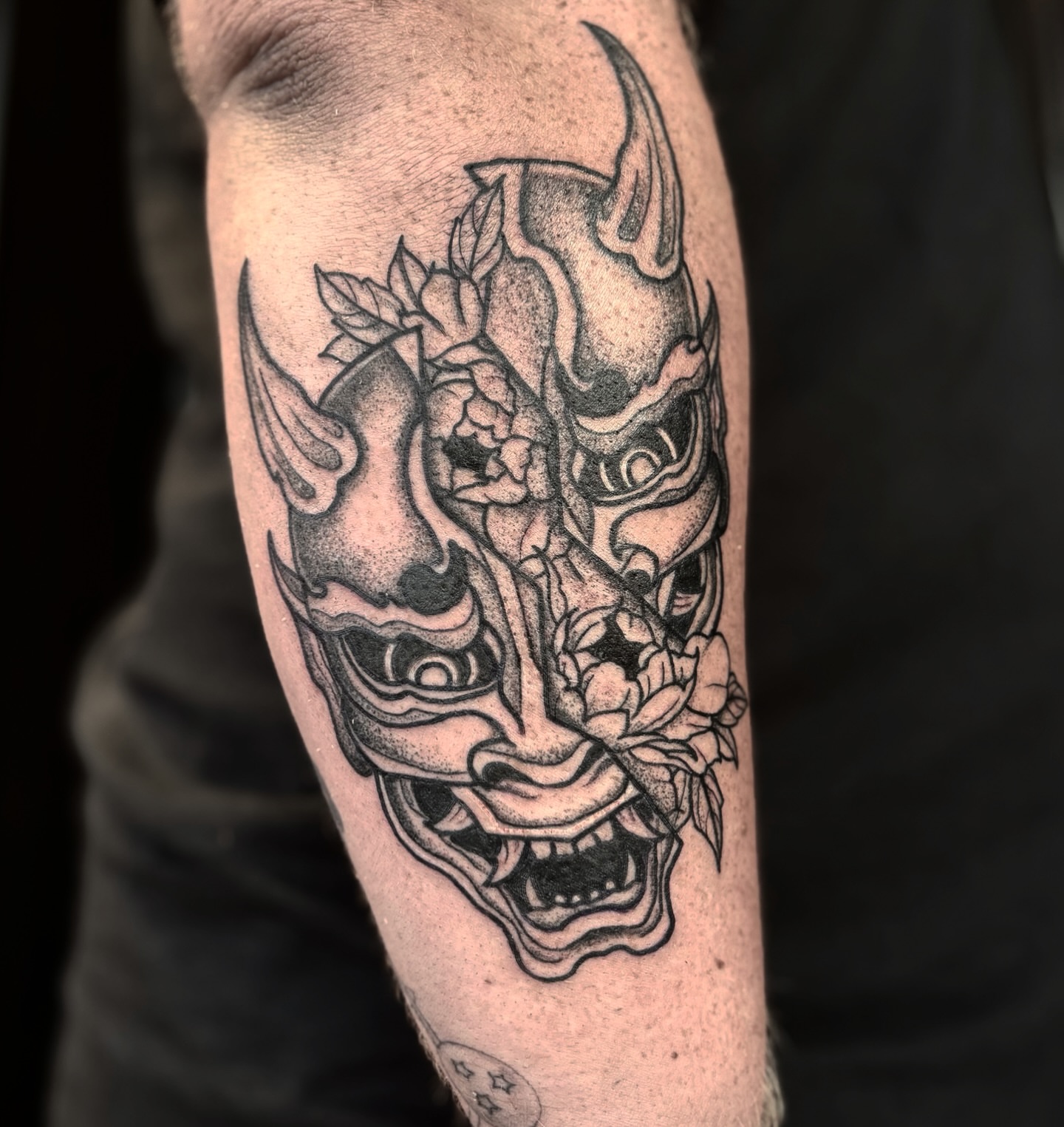 Mask with flowers dotwork tattoo on the forearm by Nashville Tattoo Artist