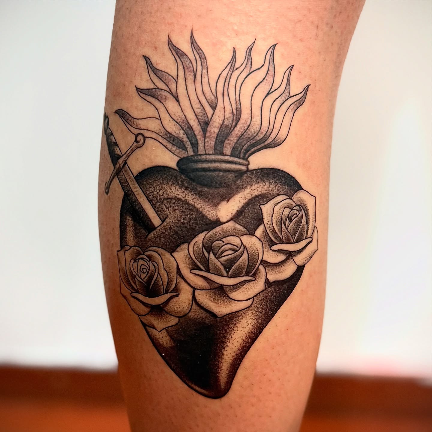 Heart with roses and anchor dotwork tattoo on the forearm by Meza Cruz