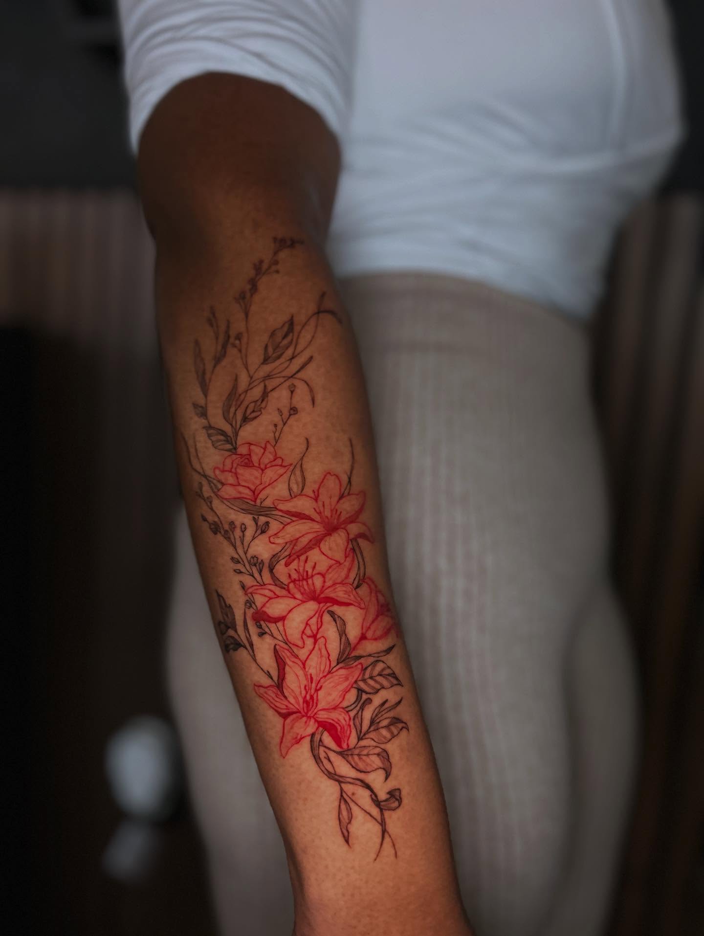 Lilies new school tattoo on the forearm by J