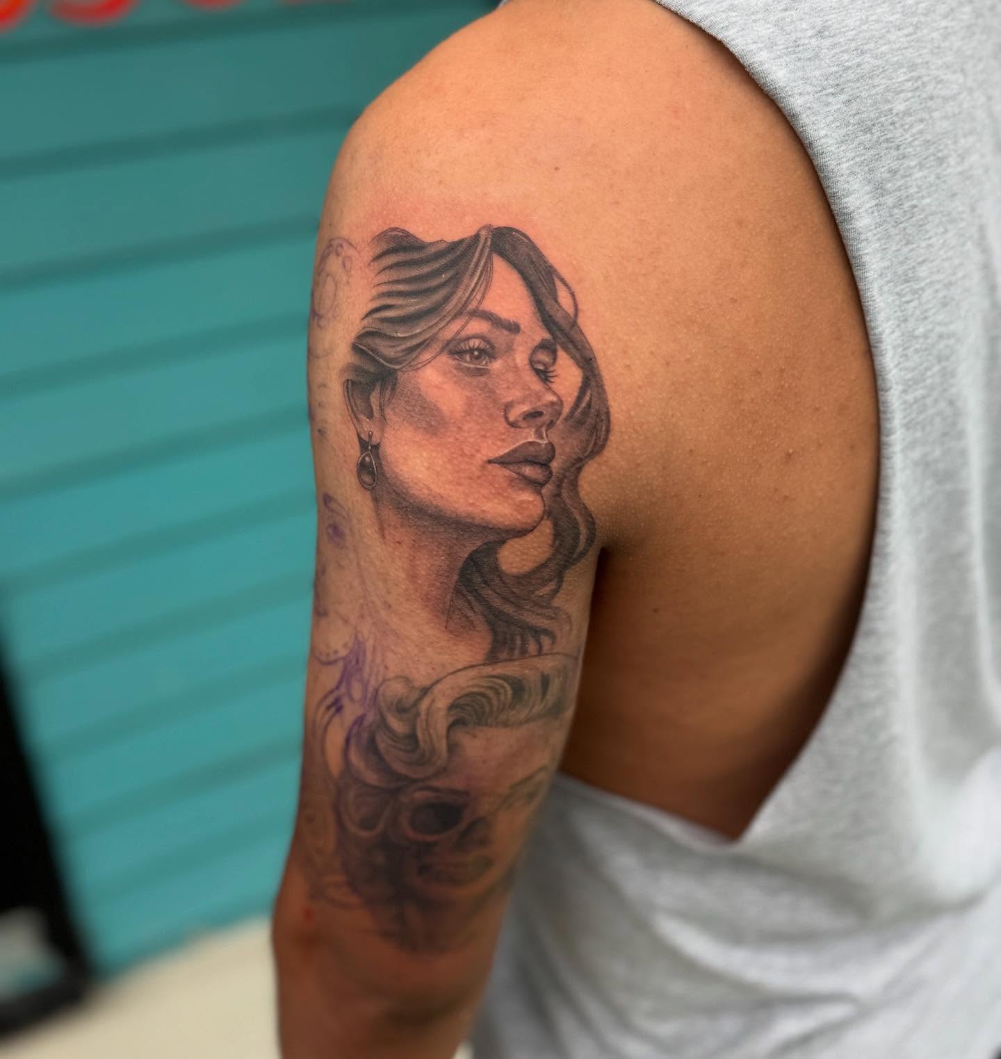 Portrait realism tattoo on the shoulder by Leslea Hipp