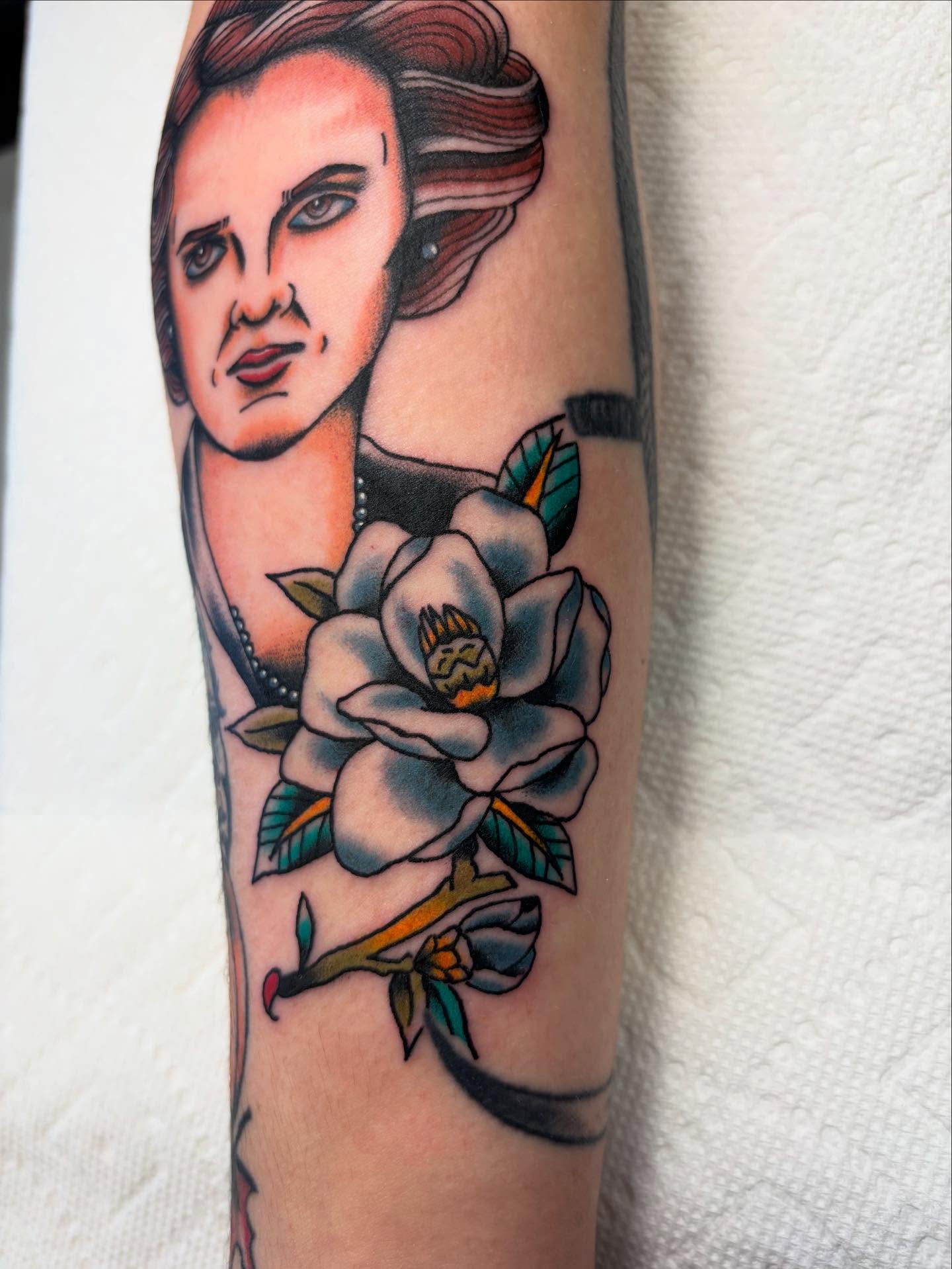 Portrait with magnolia American traditional tattoo on the forearm by Ben Whyte