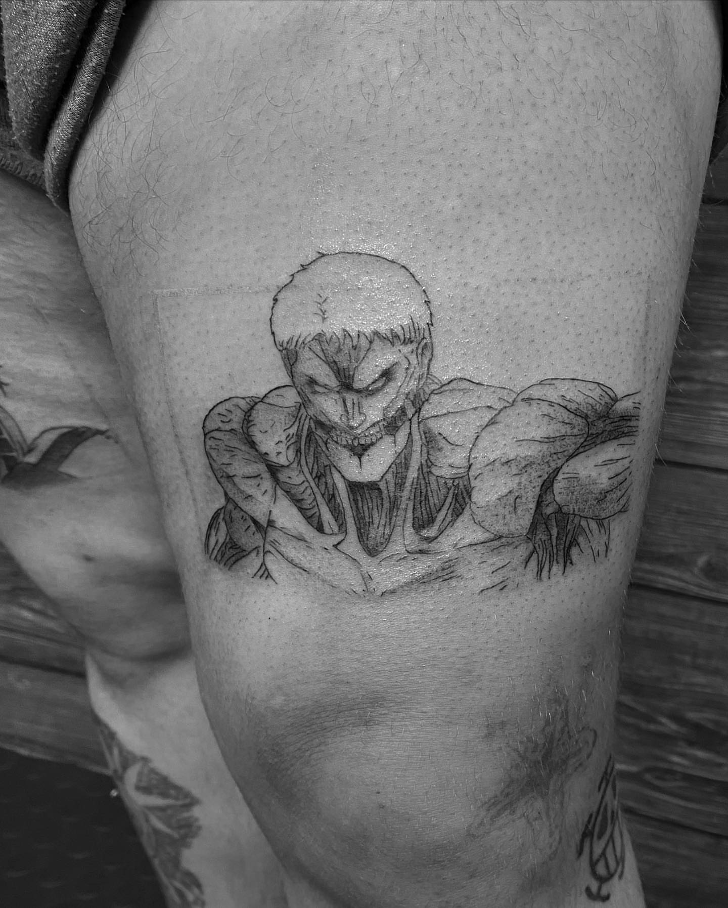 Joker black and grey tattoo on the thigh by Spencer Jones Tattoos